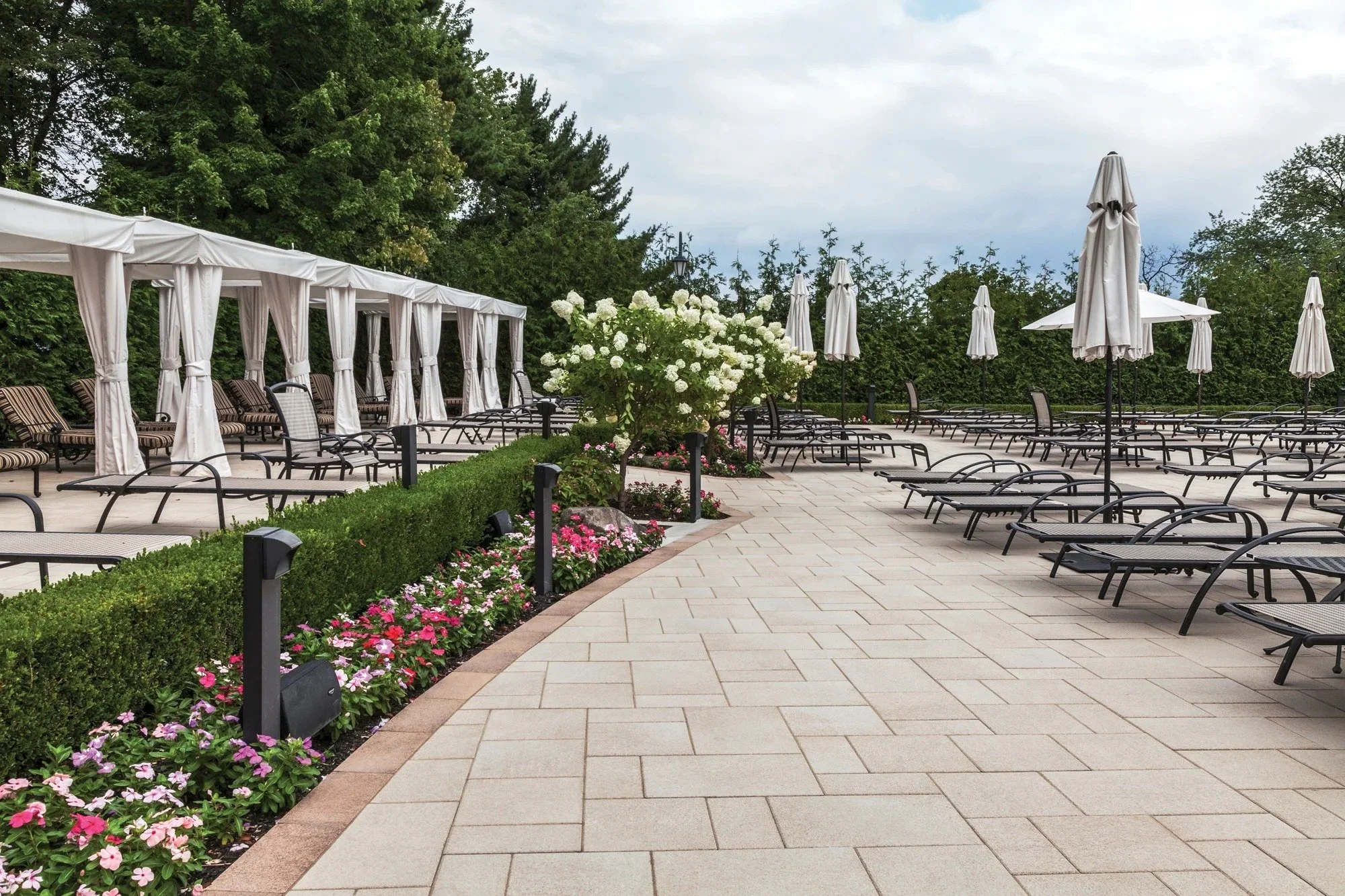 Outdoor living patio featuring paver installation and integrated stone walkways in Port Jefferson, NY