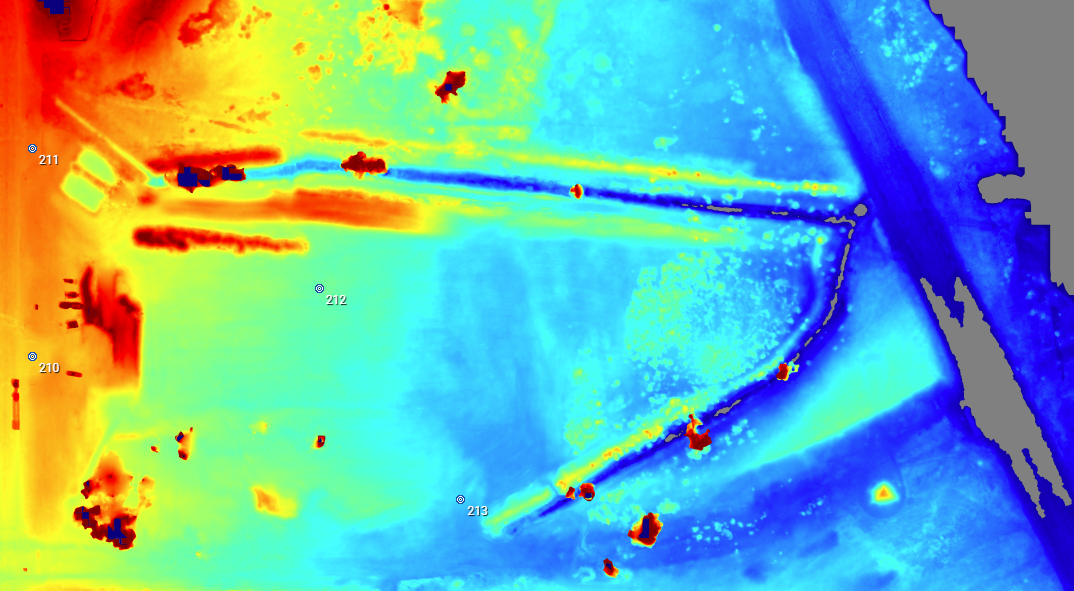 Thermal image of a boat dock with boats, water, and surrounding land.
