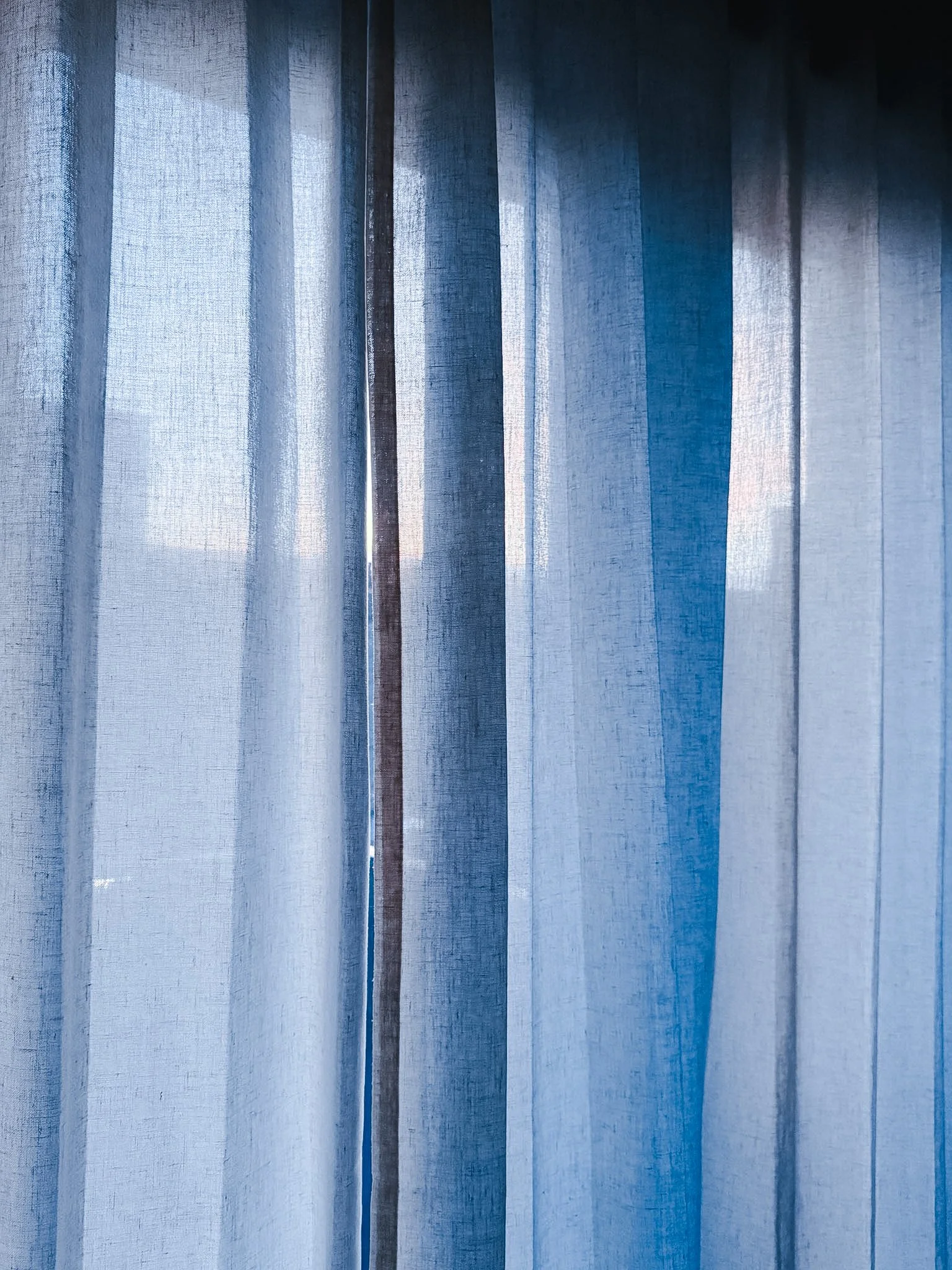 Fabric with a textured surface and varying shades of blue.