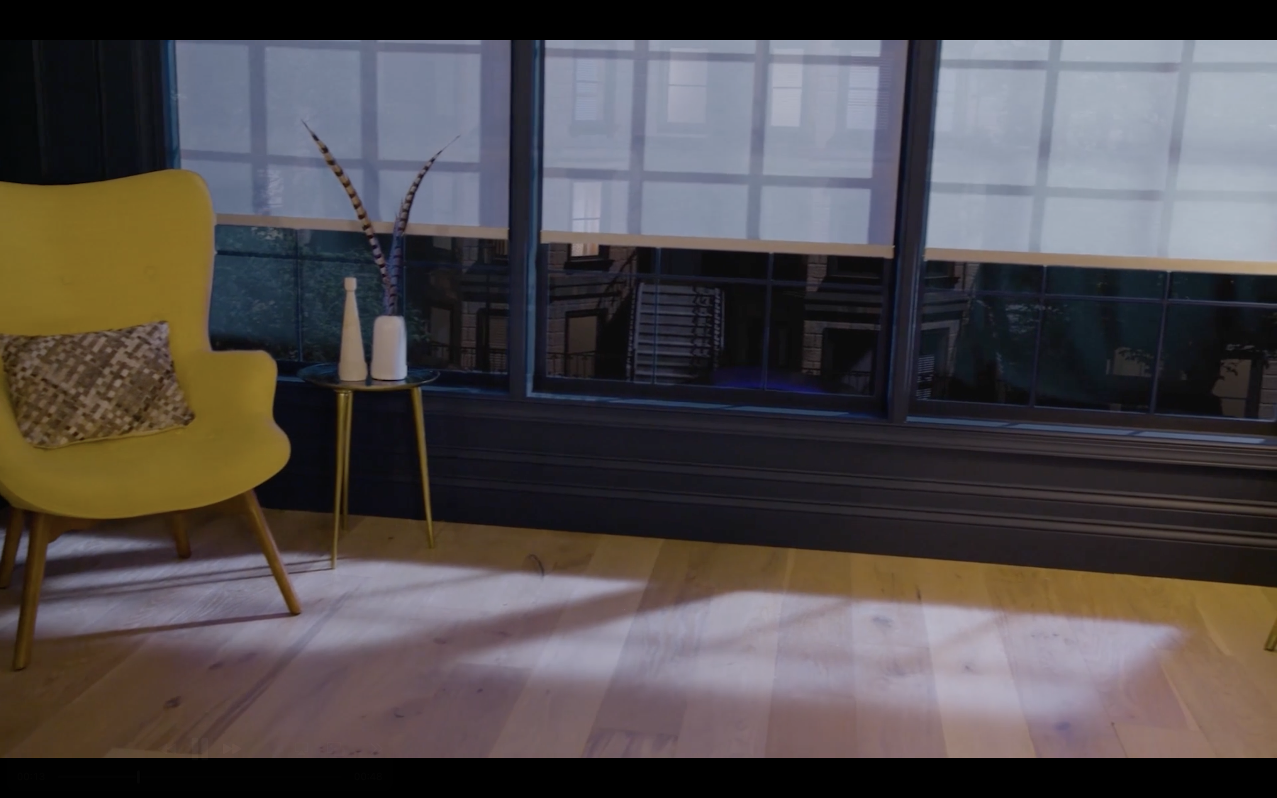 Interior of a room with a large window, a yellow chair with a patterned cushion, and a small side table with vases, hardwood flooring.