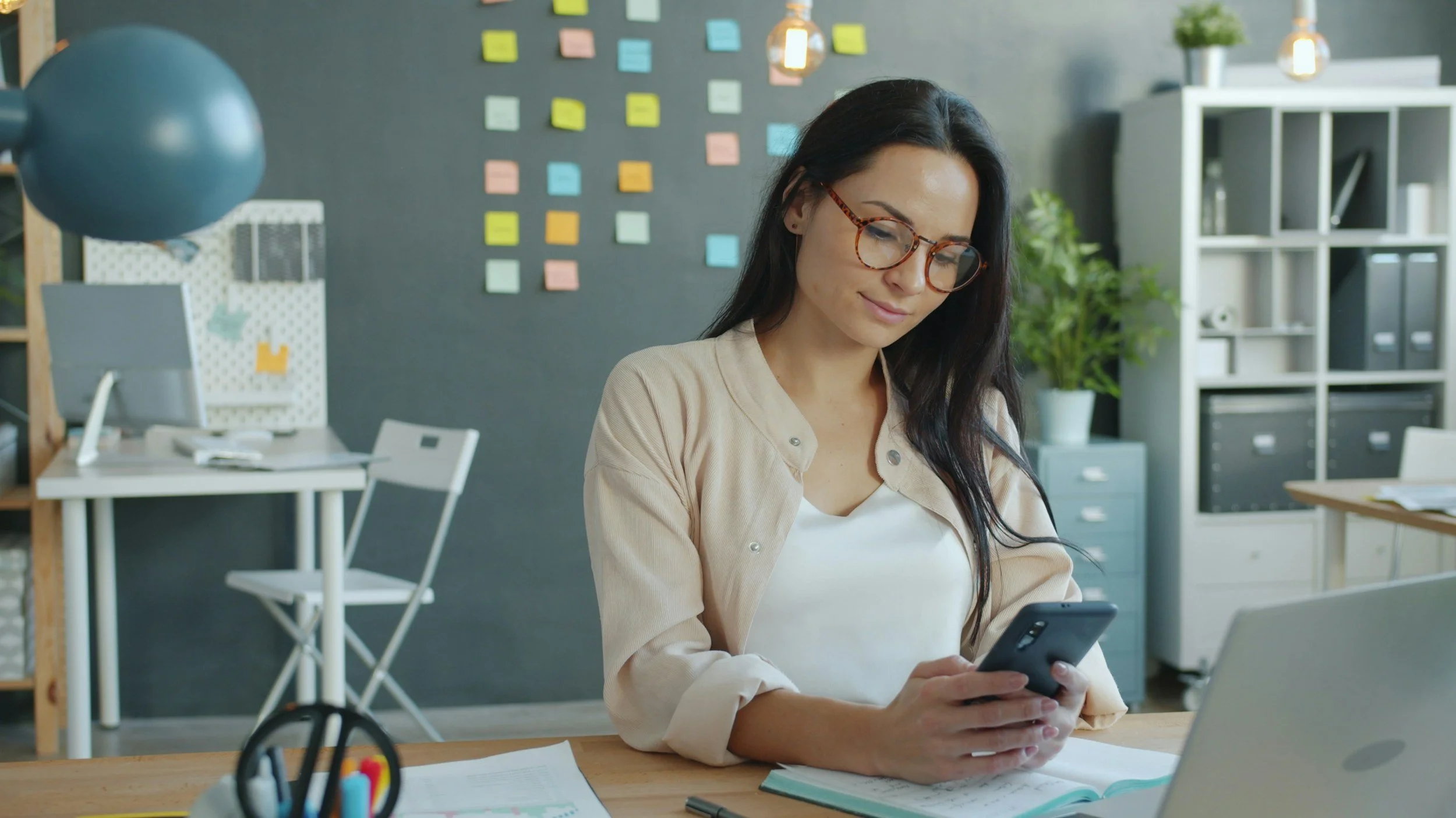 a person on their phone at their desk