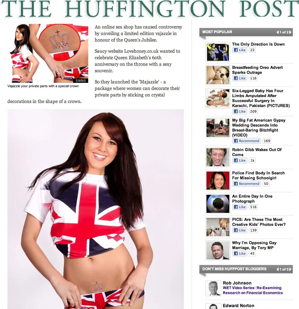 A woman wearing a t-shirt and underwear with the Union Jack flag design, smiling and posing against a plain background.