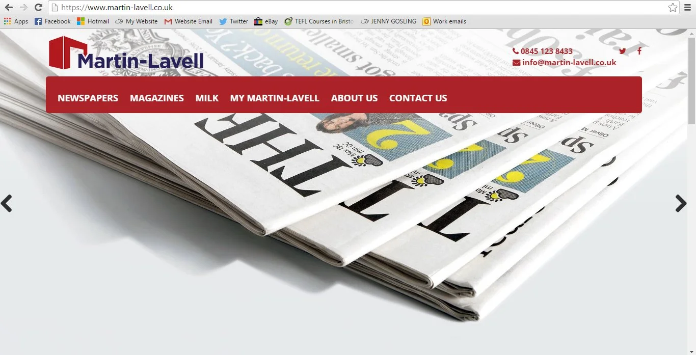 Stack of folded newspapers with a red and white website banner at the top.