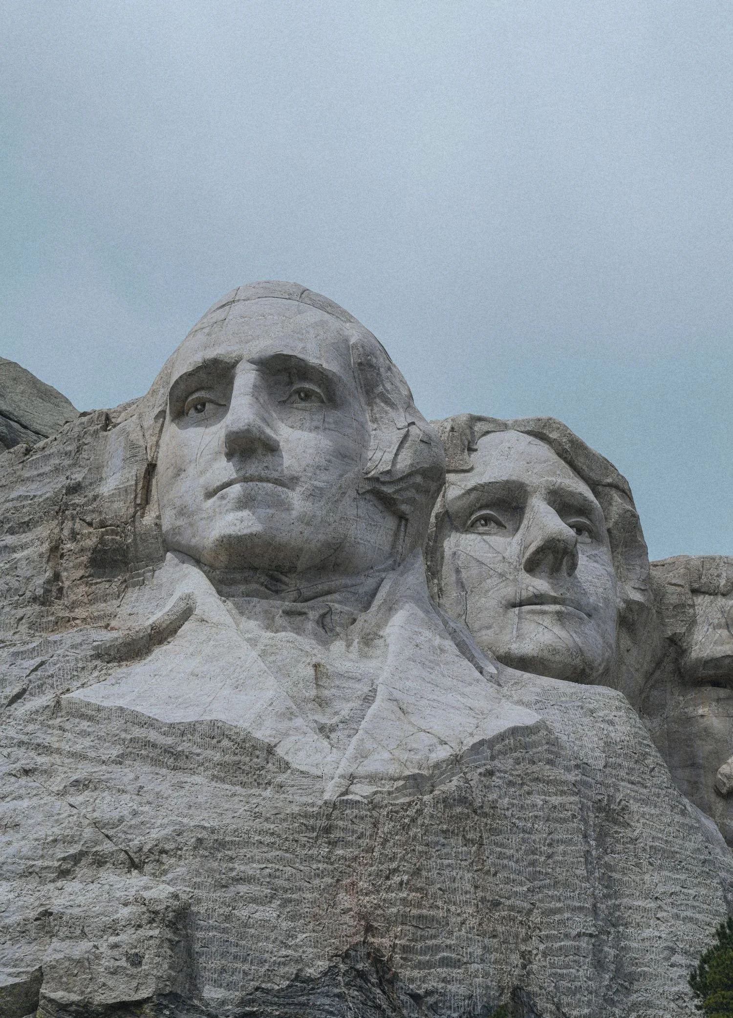 Close-up of Mount Rushmore with the carved faces of four U.S. presidents against a clear sky.