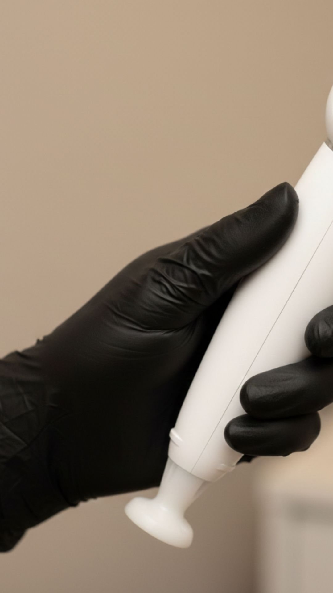 Jet Plasma device being held in a black gloved hand