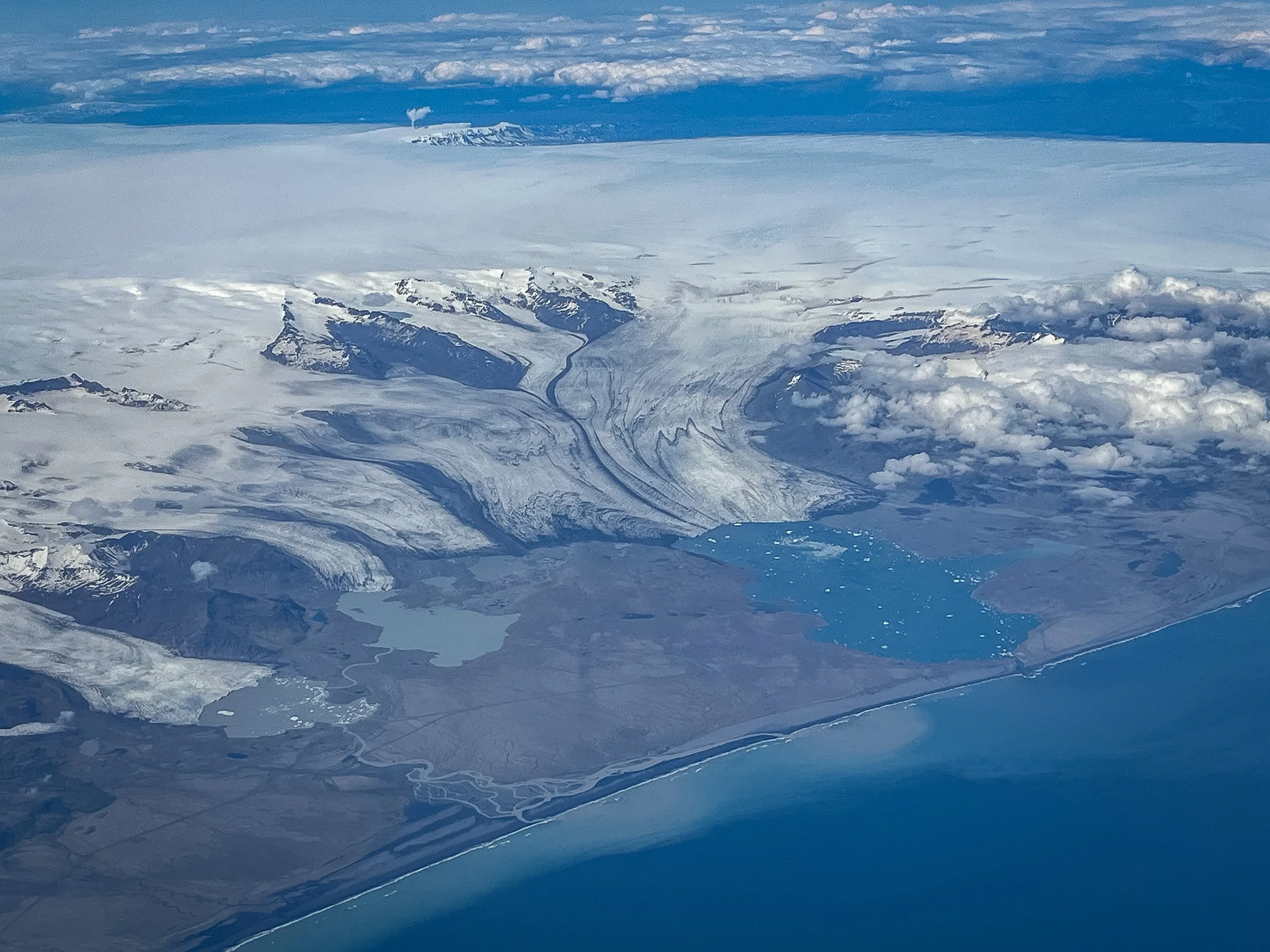South Iceland from the air — Vatnajökull’s glacier tongues flowing towards Jökulsárlón and the Atlantic coastline, a map of ice, water and black sand.