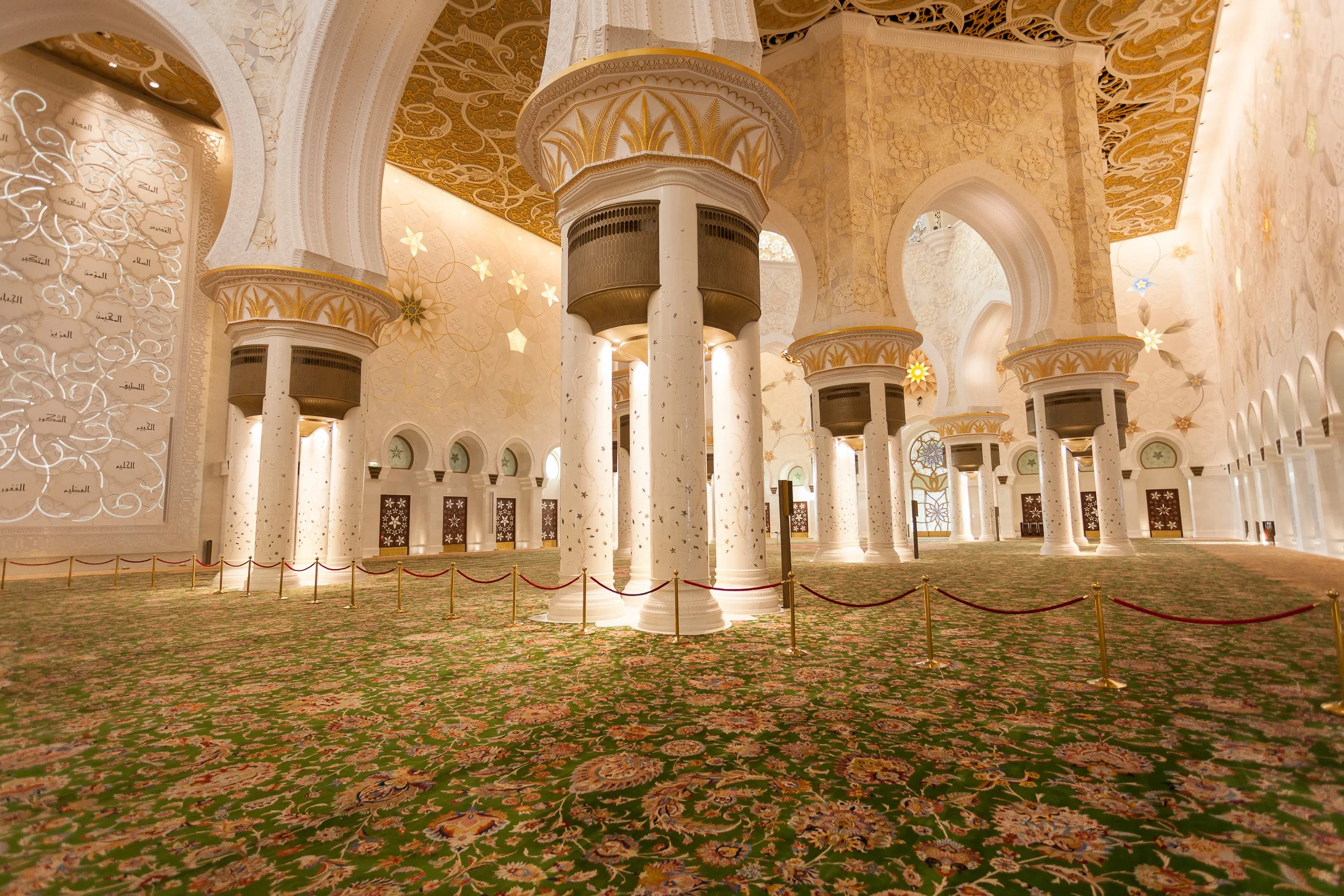 The vast prayer hall of Sheikh Zayed Grand Mosque, rich with detail and symmetry, Abu Dhabi.