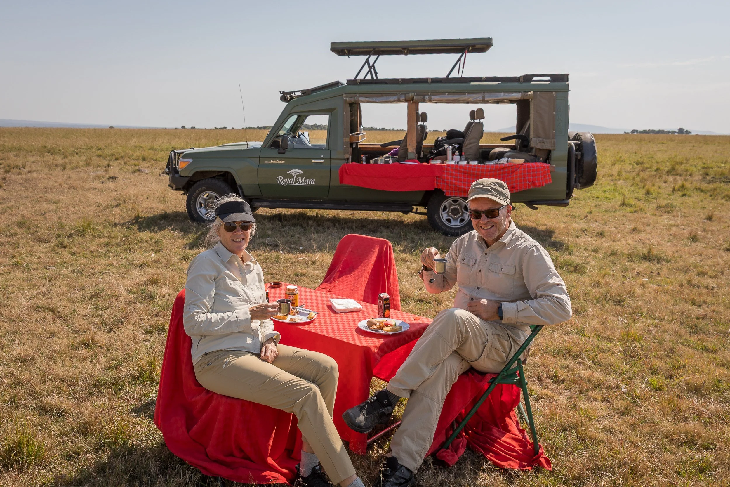 Breakfast in Maasai Mara National Reserve, Kenya – outdoor table, chairs and morning light in the middle of the bush.