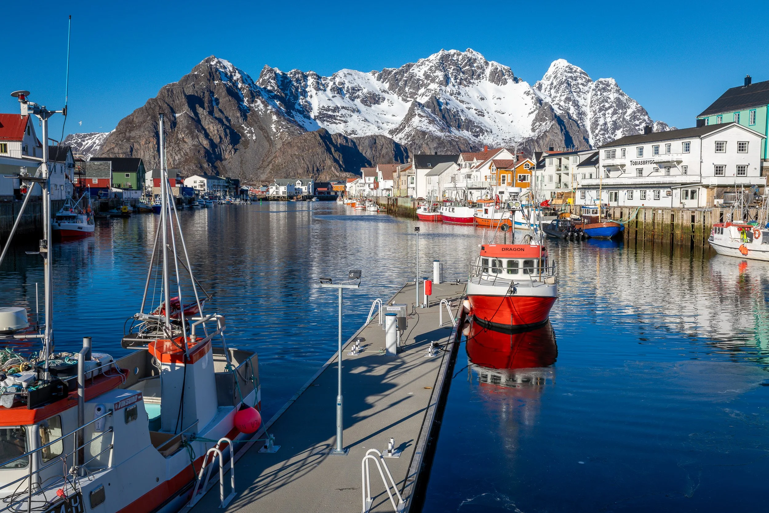 Henningsvær fishing village in the Lofoten Islands, Norway – narrow islands, harbour and football pitch surrounded by open sea.