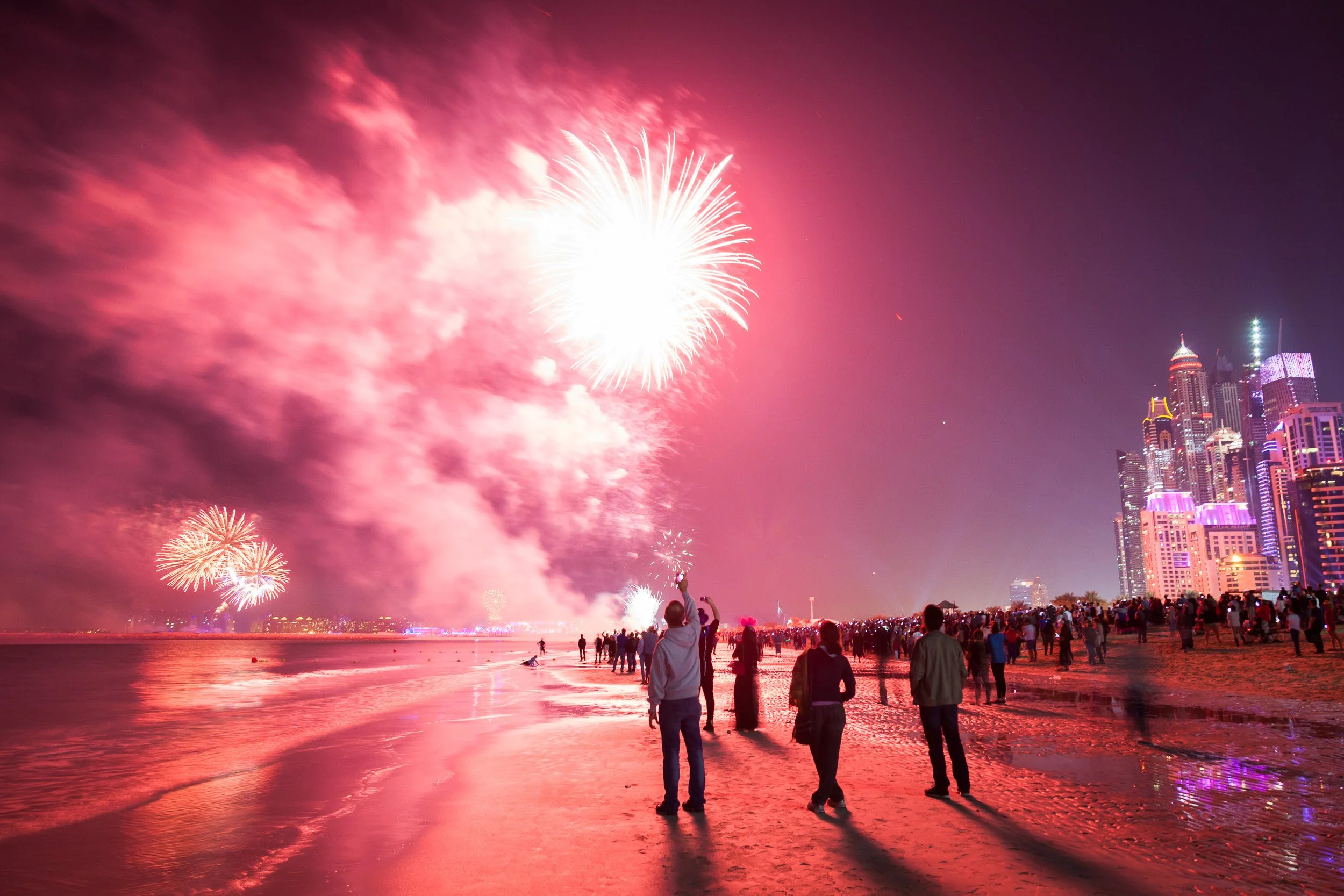 Fireworks lighting up the beach and skyline in a blaze of colour on a festive night in Dubai.