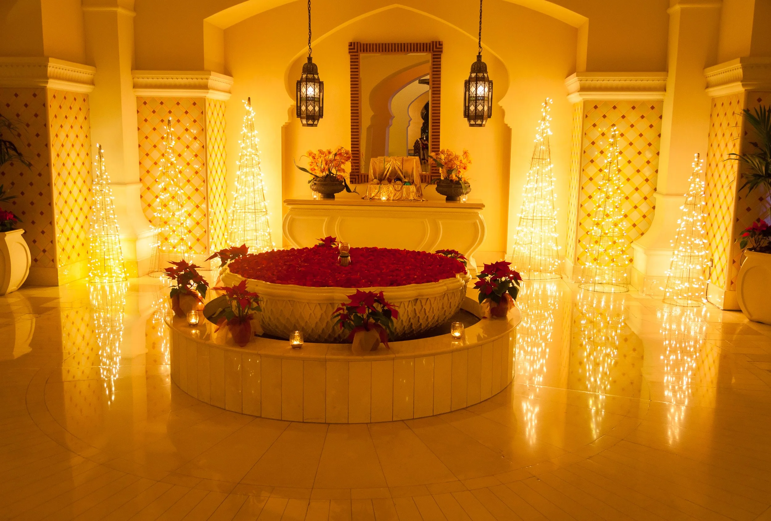 A glowing floral display and festive lights bringing a theatrical touch to an elegant Dubai interior.