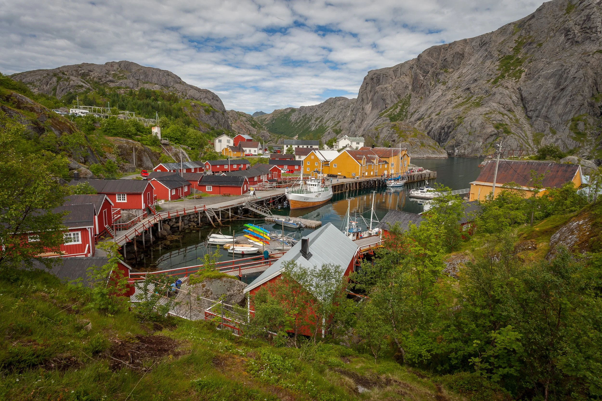 Fisherman’s cabins in Nusfjord, Lofoten Islands, Norway – historic red rorbuer clustered around a sheltered harbour.