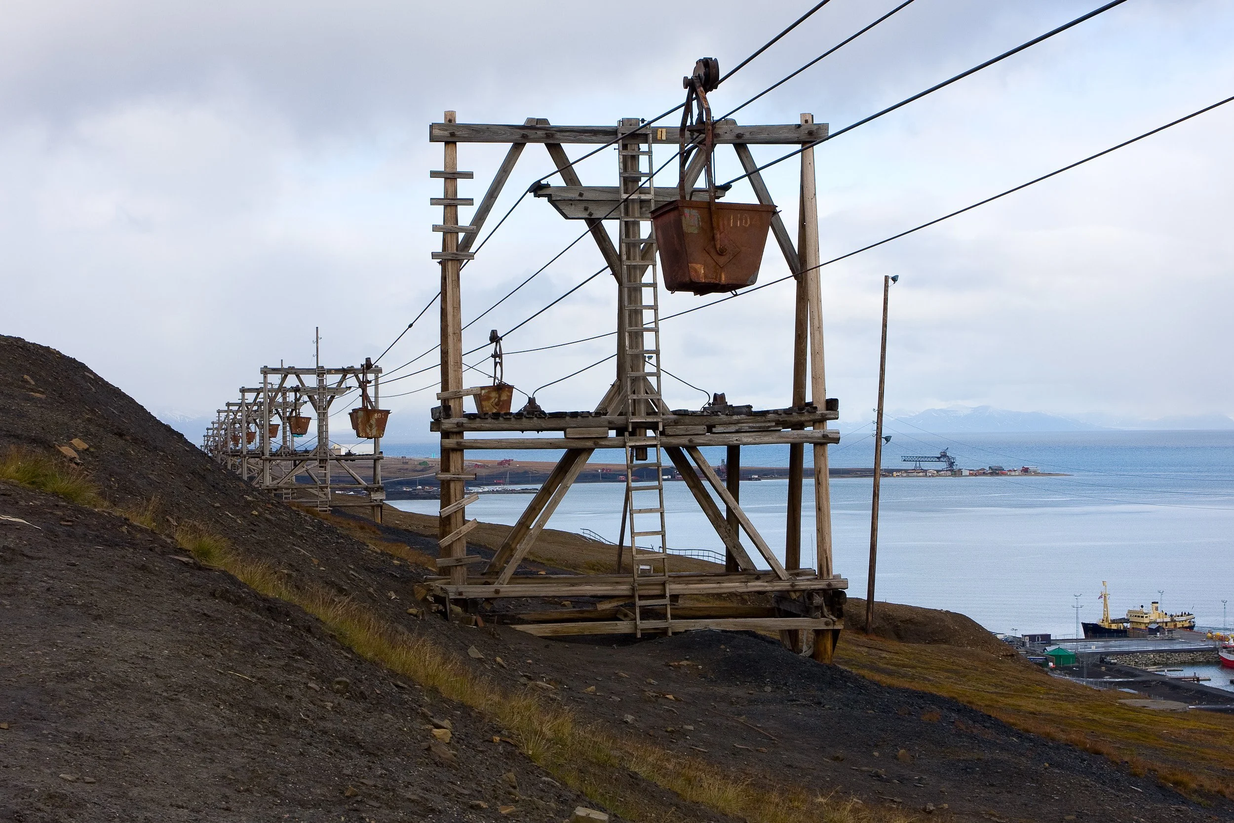 Old cableway towers above Longyearbyen trace the industrial lines that still shape the landscape.