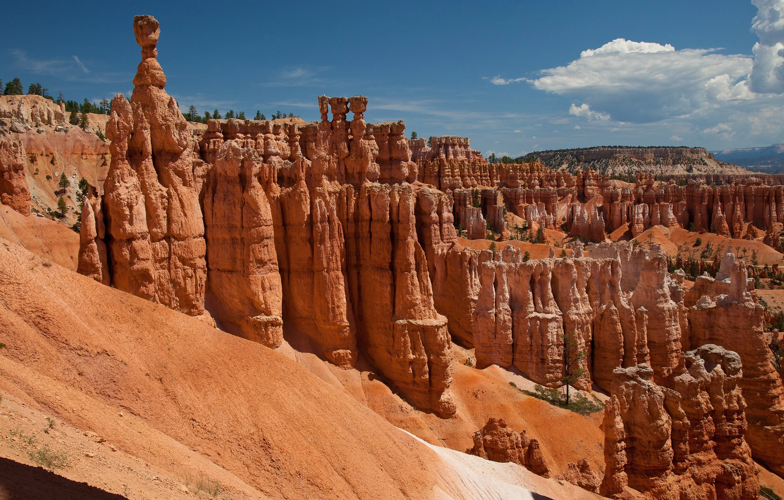 Towering hoodoos beneath a summer sky in Bryce Canyon National Park, Utah.