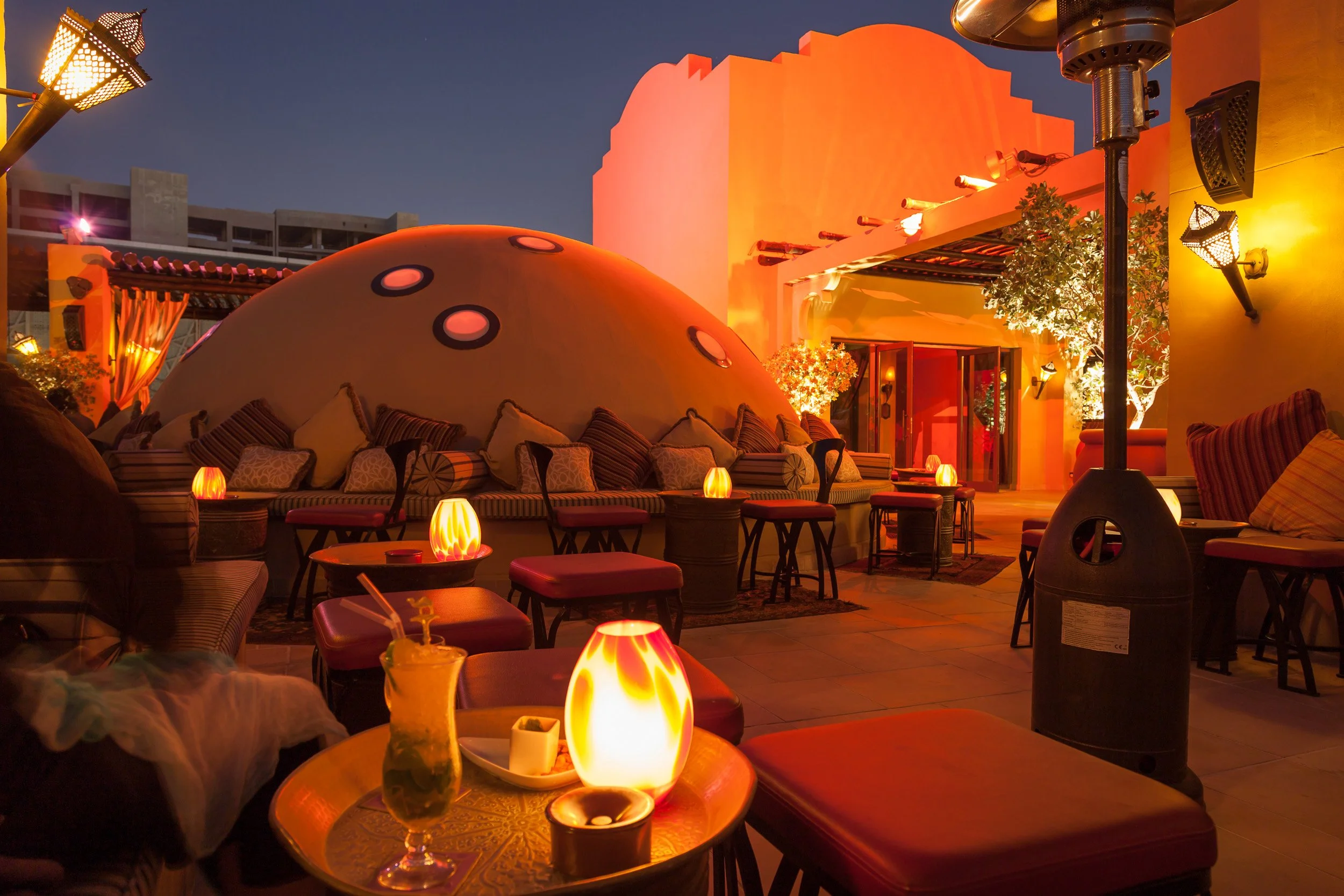 Warm lantern light and Arabian-inspired design creating an intimate evening atmosphere in Dubai.