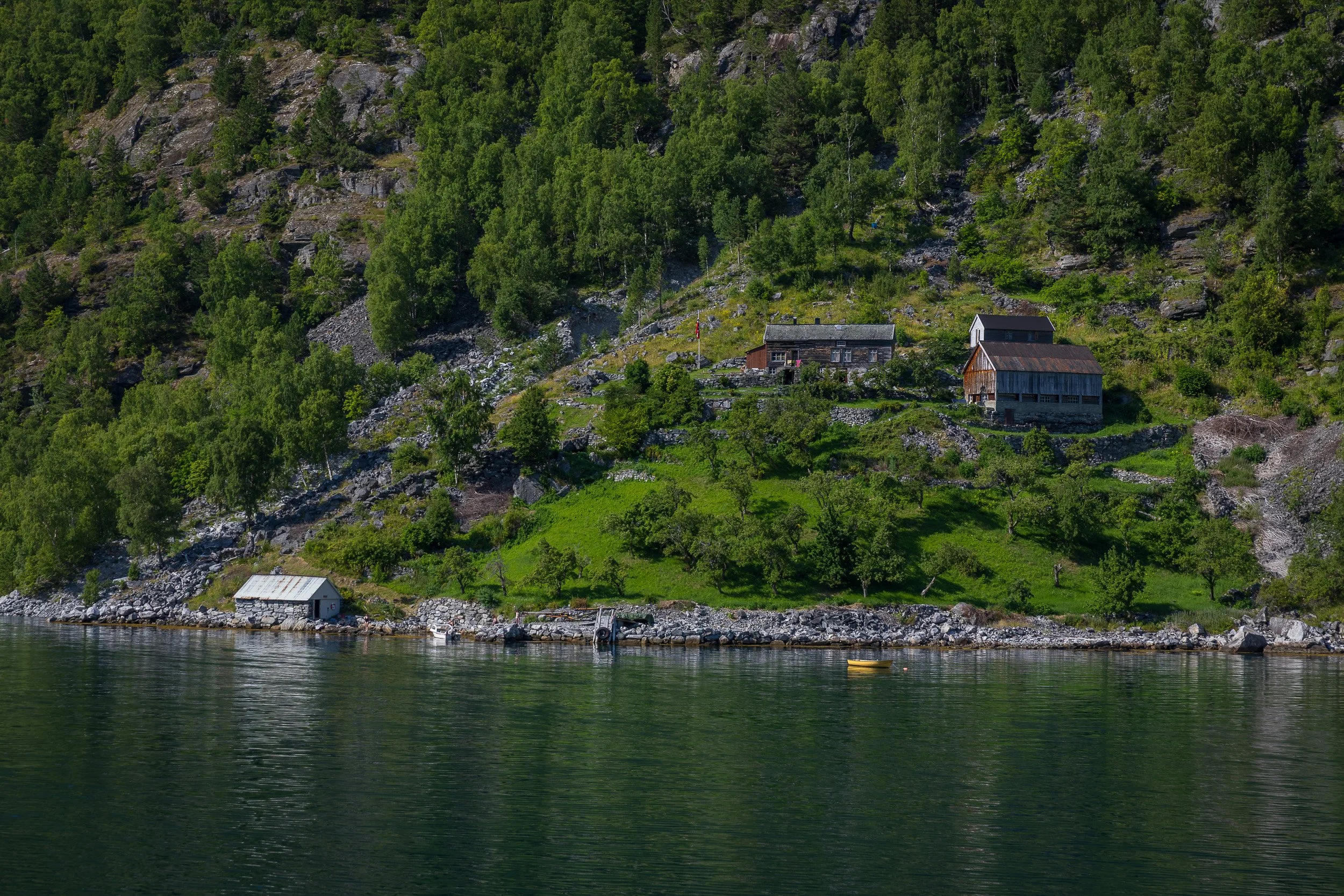 Old historic buildings clinging to the slopes of Geirangerfjorden — a reminder of lives once lived on Norway’s steepest edges.
