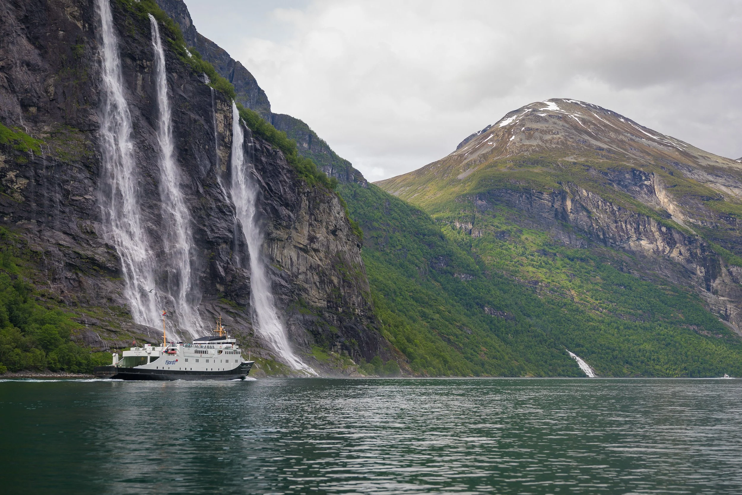 Geirangerfjord with waterfalls and cliff faces rising straight from the water — raw, powerful, and unmistakably Norwegian.