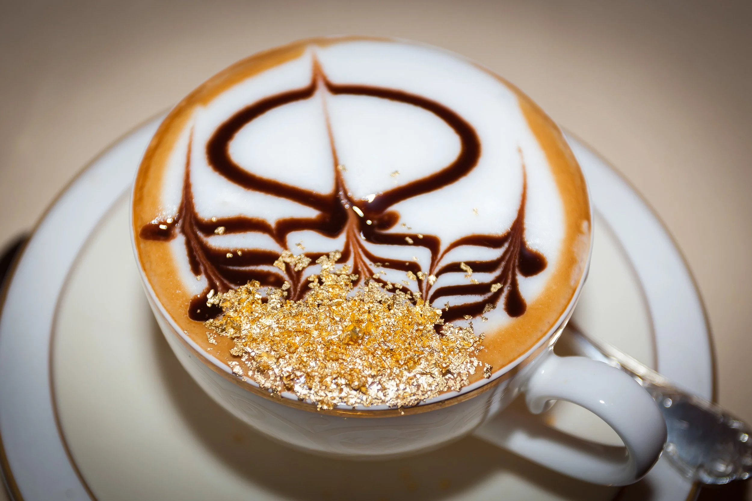 Afternoon tea at Emirates Palace, Abu Dhabi, where coffee is elevated to spectacle with chocolate art and a touch of gold.