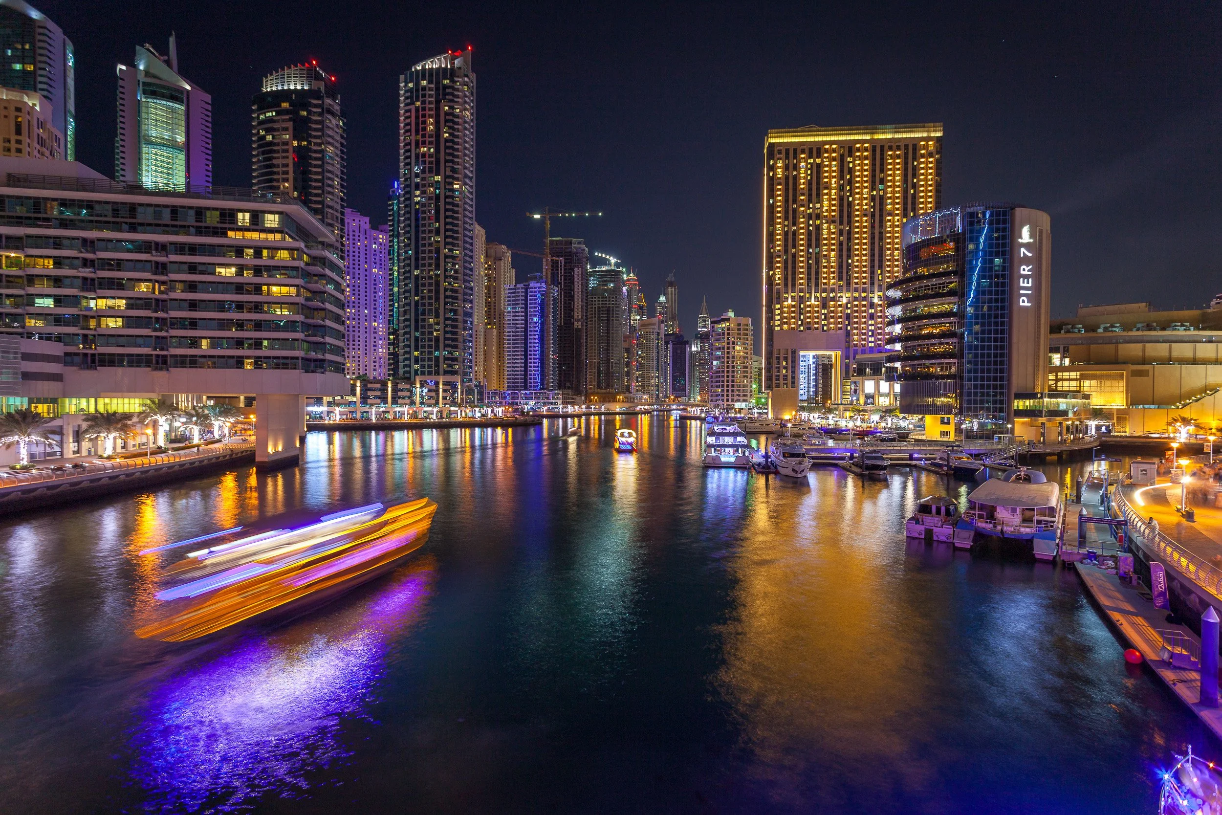 A blur of colour from a passing boat beneath the neon-lit towers of Dubai Marina.