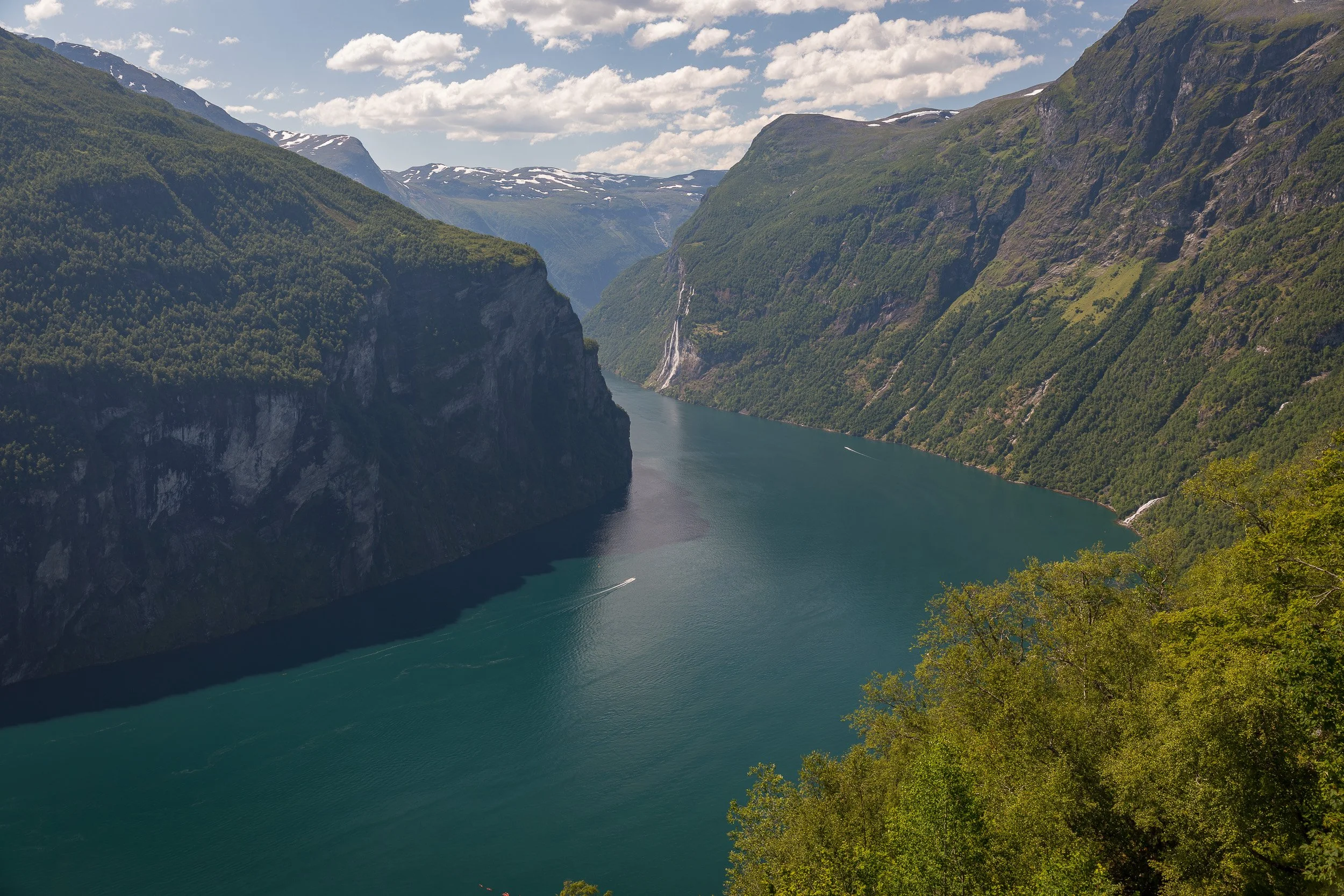 High above Geirangerfjorden — Norway’s most famous fjord, the water turns deep turquoise as it curves between steep mountains, a landscape that feels like Norway at full volume.