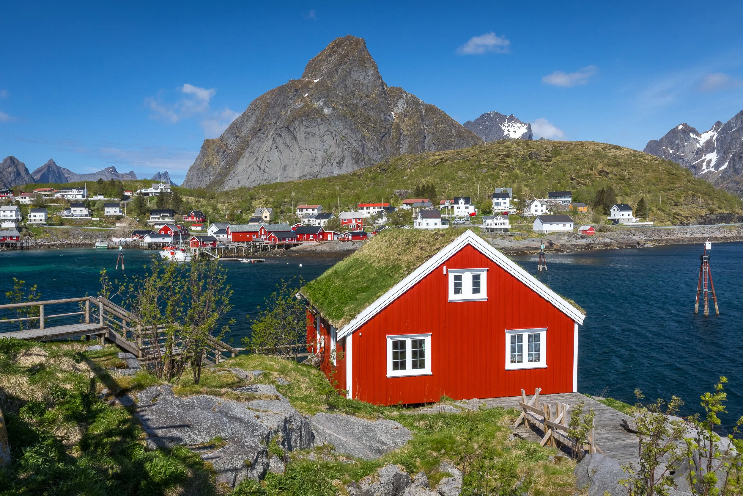 Fisherman’s cabins in Reine, Lofoten Islands, Norway – traditional boathouses and walkways along the edge of the fjord.