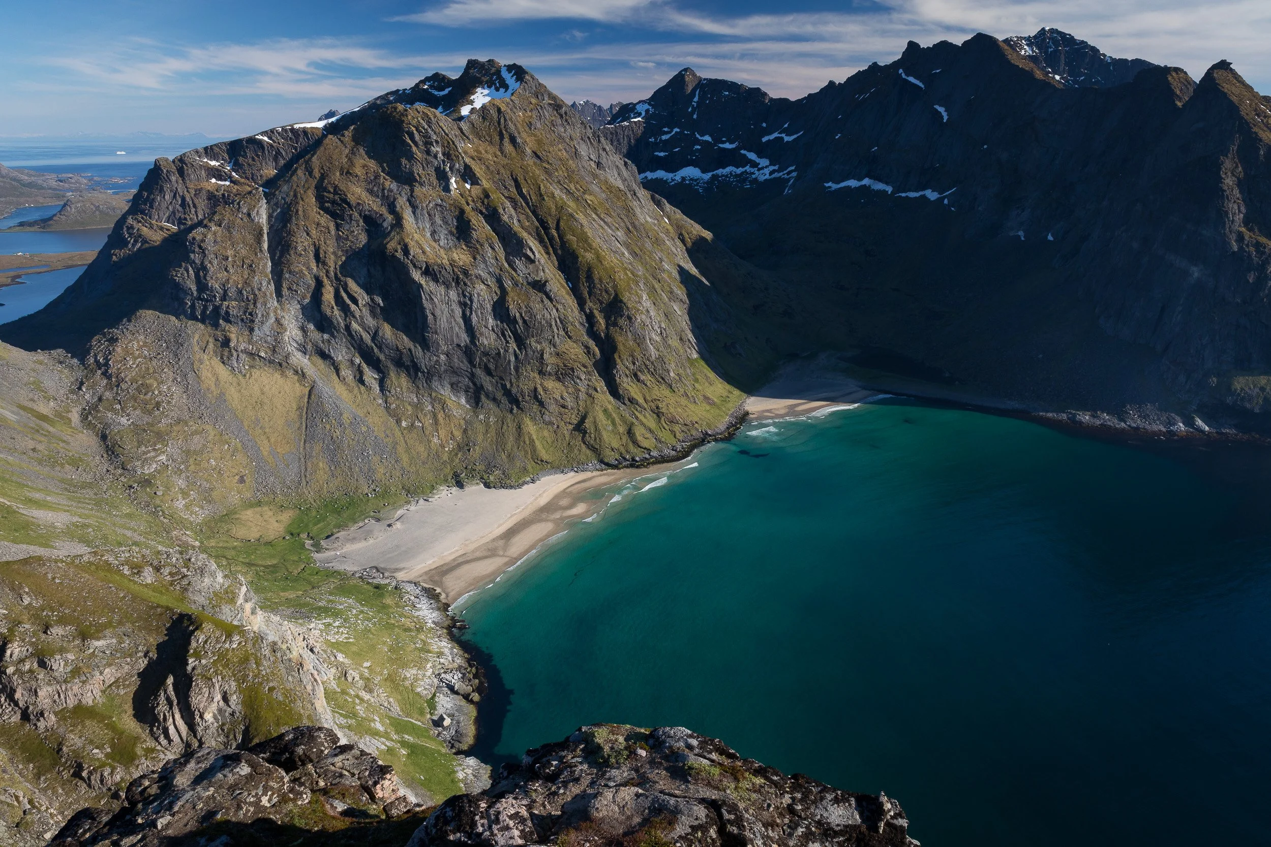Kvalvika Beach in the Lofoten Islands, Norway – golden sand and surf framed by high cliffs on the wild Atlantic side.