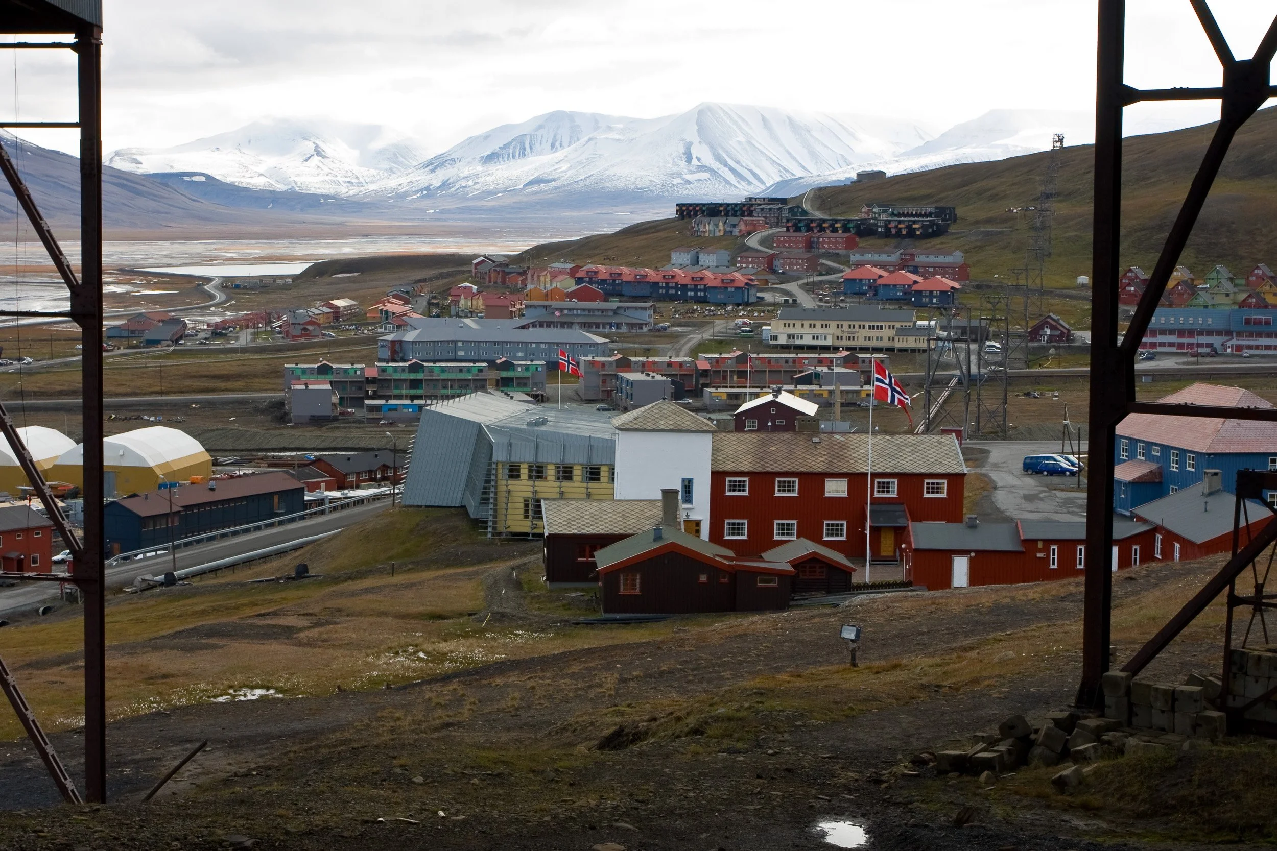 Longyearbyen spreads across the valley floor beneath broad mountains, showing how small the settlement remains in the High Arctic.