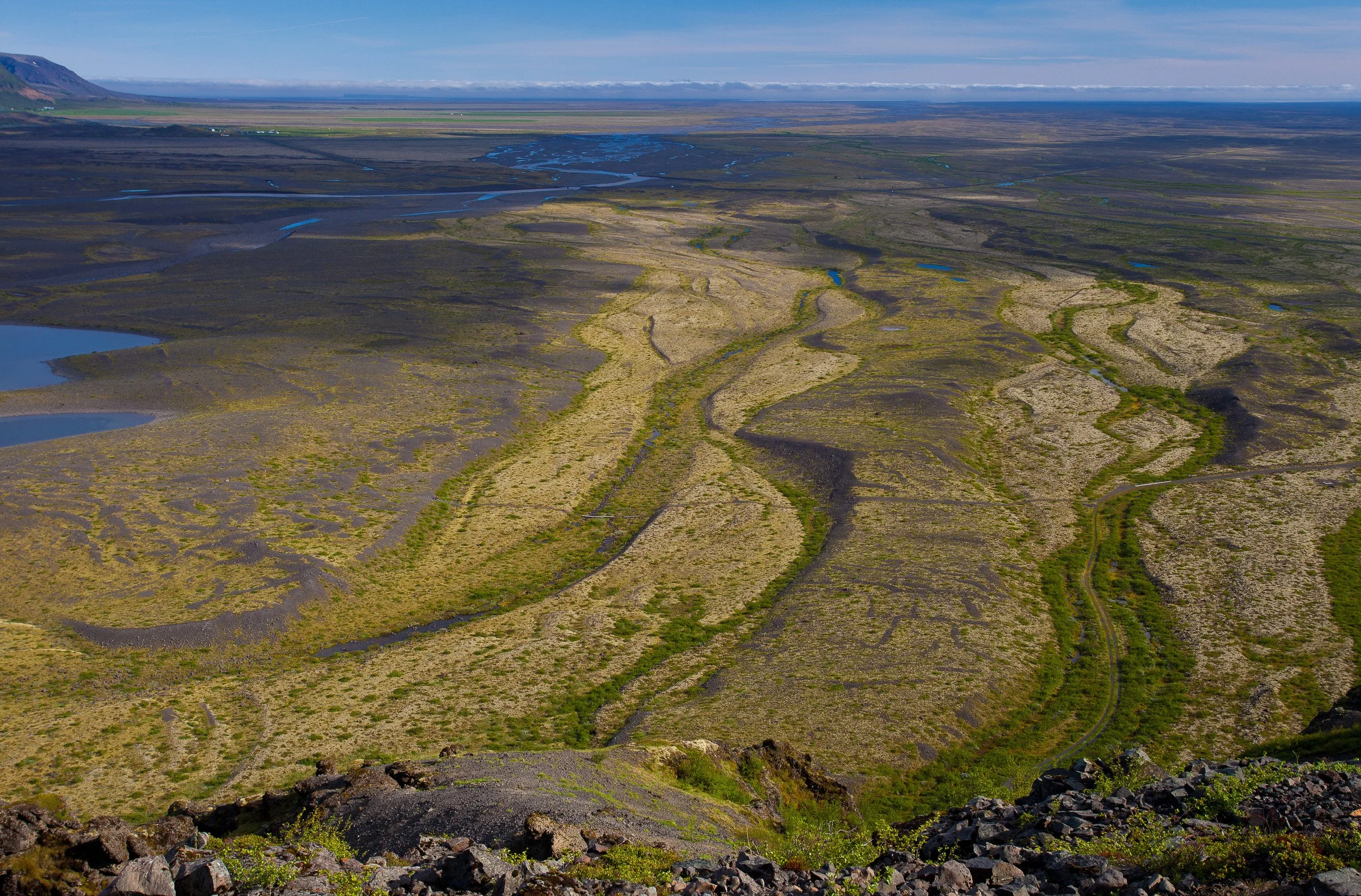 Skaftafell, Iceland — braided glacial rivers stitch pale channels across the vast sandur plain at the edge of Vatnajökull.