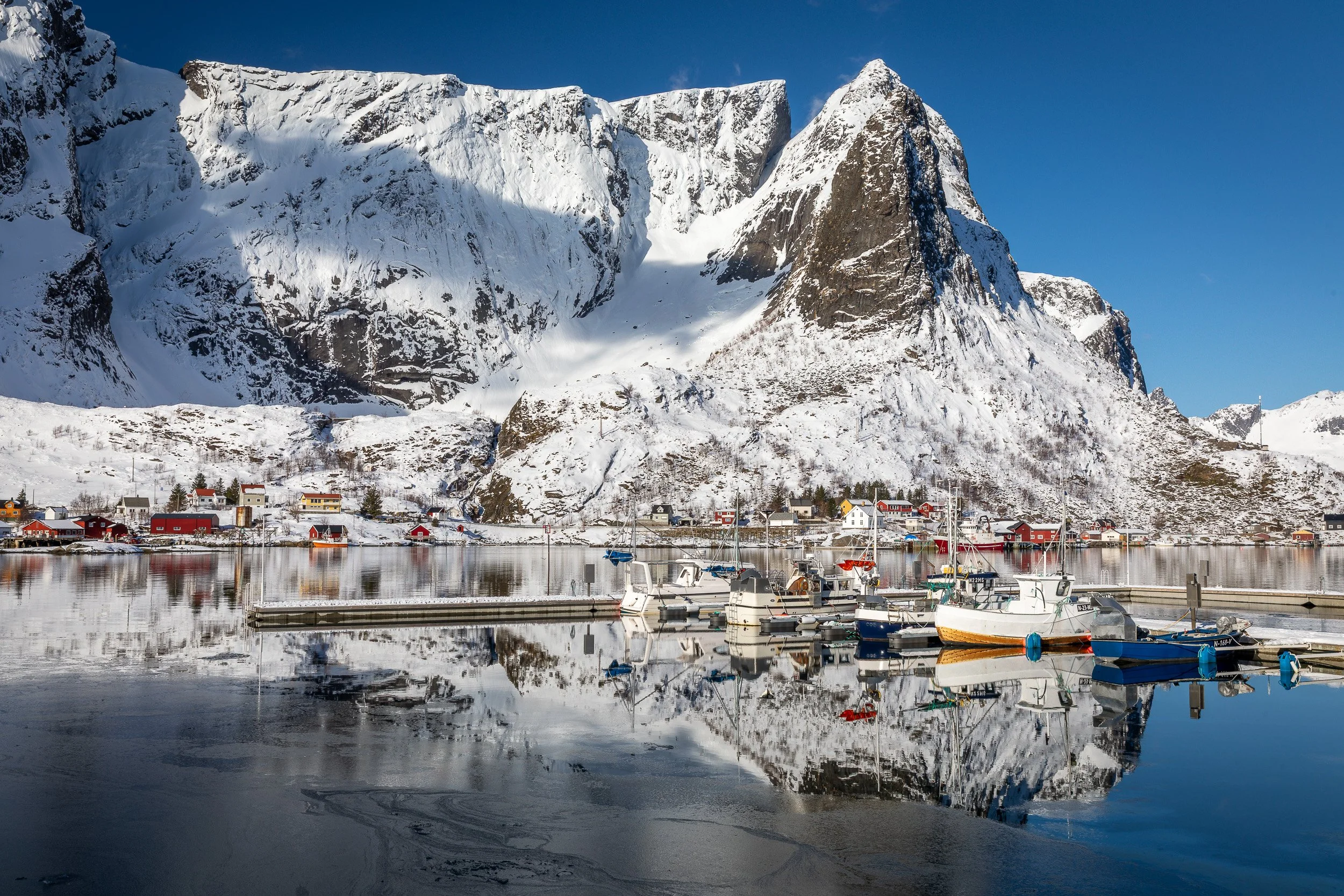 Reine, Lofoten Islands, Norway – postcard-perfect fishing village with red cabins and towering granite peaks.