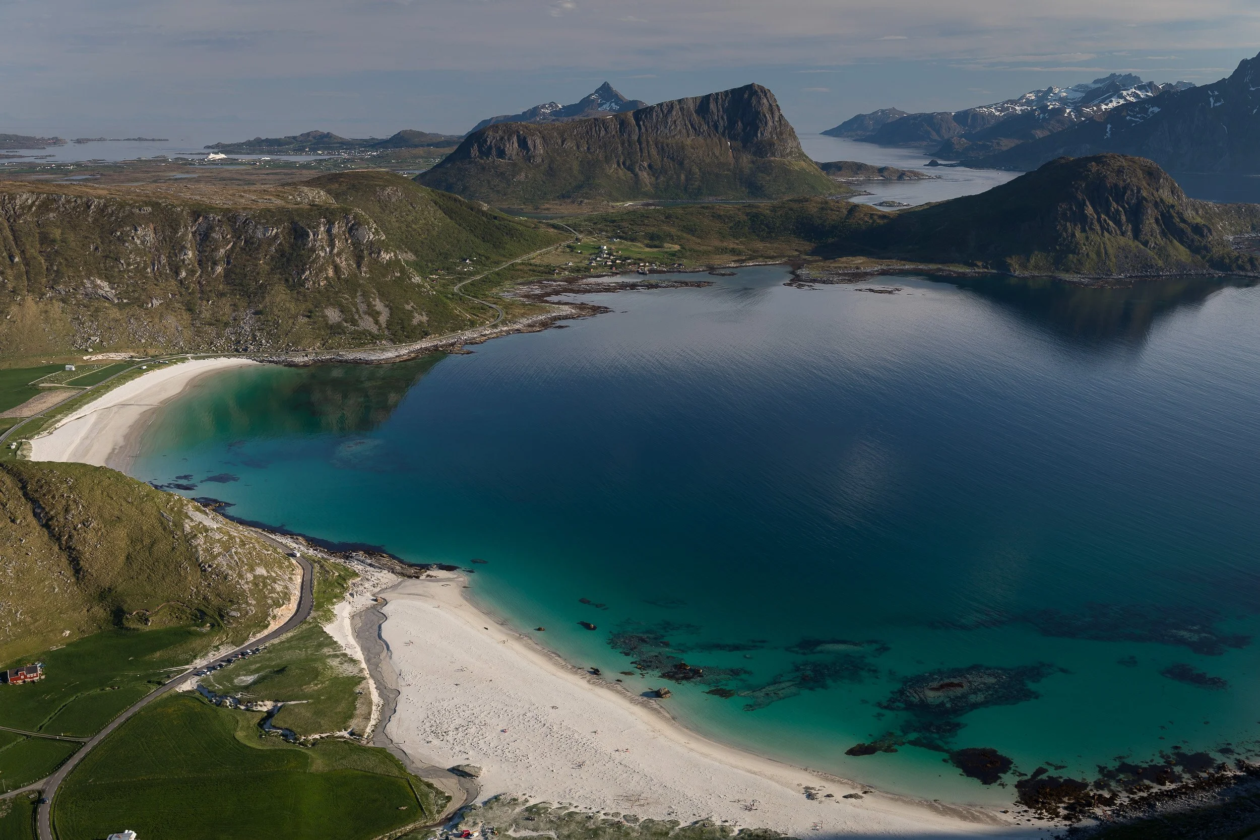 Haukland Beach in the Lofoten Islands, Norway – white sand and turquoise bay framed by rounded coastal mountains.