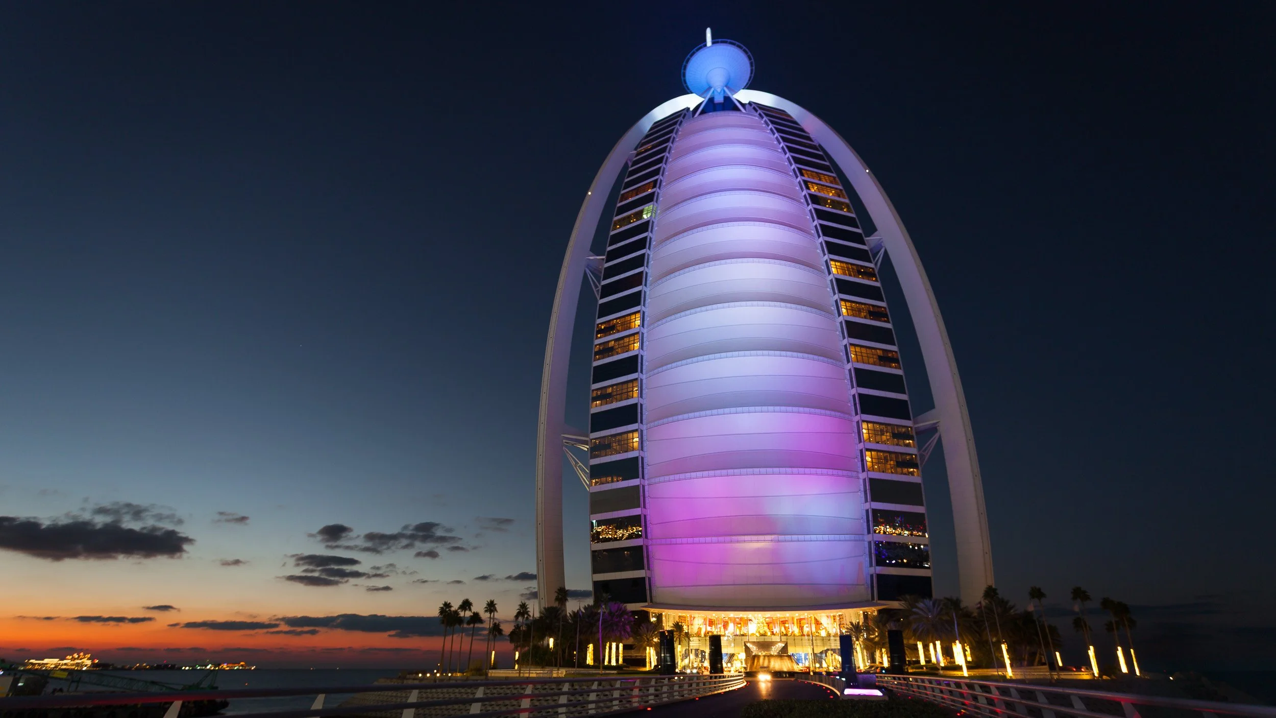 Burj Al Arab in Dubai, United Arab Emirates – iconic sail-shaped hotel illuminated against the dark Arabian Gulf.