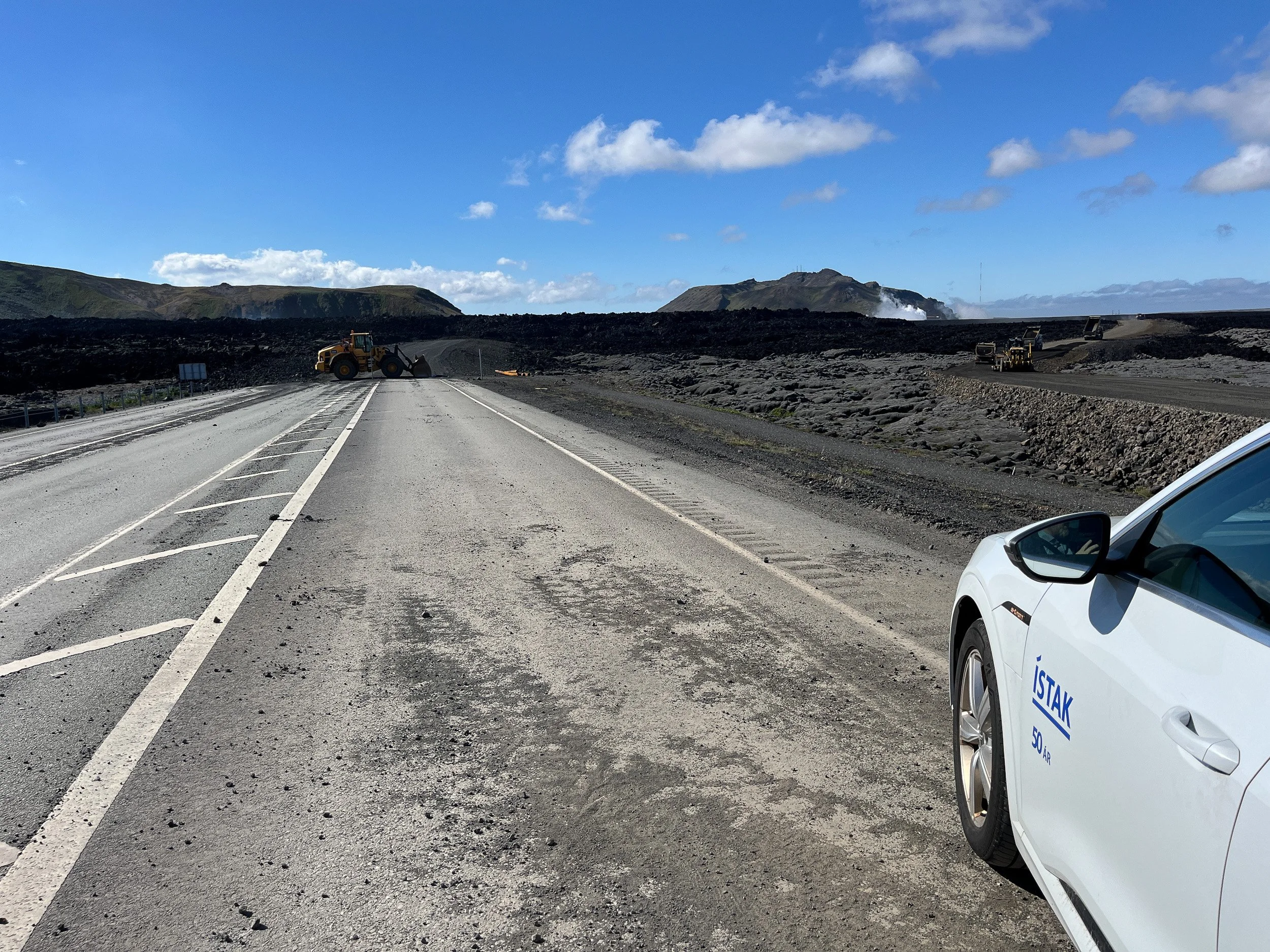 The road closed after a volcanic eruption near Grindavik in 2024, with fresh lava fields and heavy machinery marking how quickly Iceland reshapes itself.