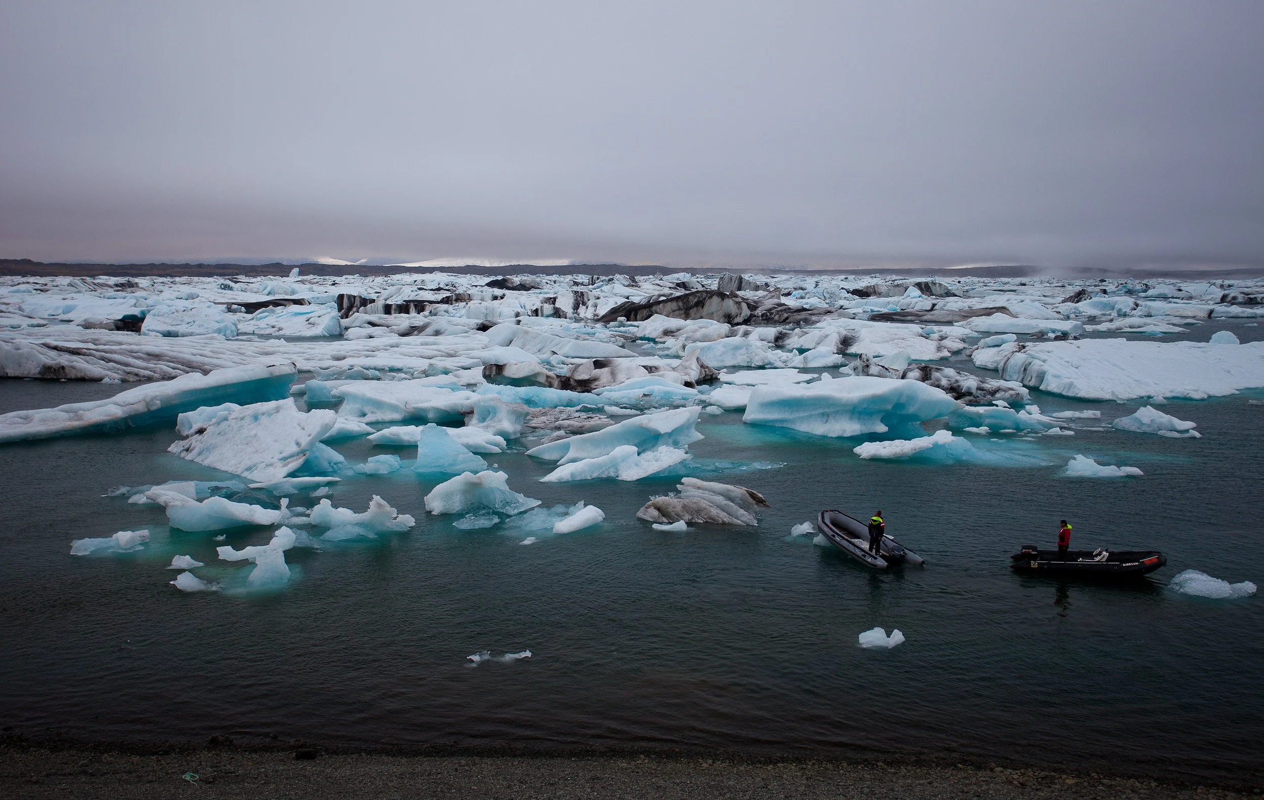Jökulsárlón, Iceland — inflatable boats weave between icebergs, turning the lagoon into a slow, floating labyrinth.