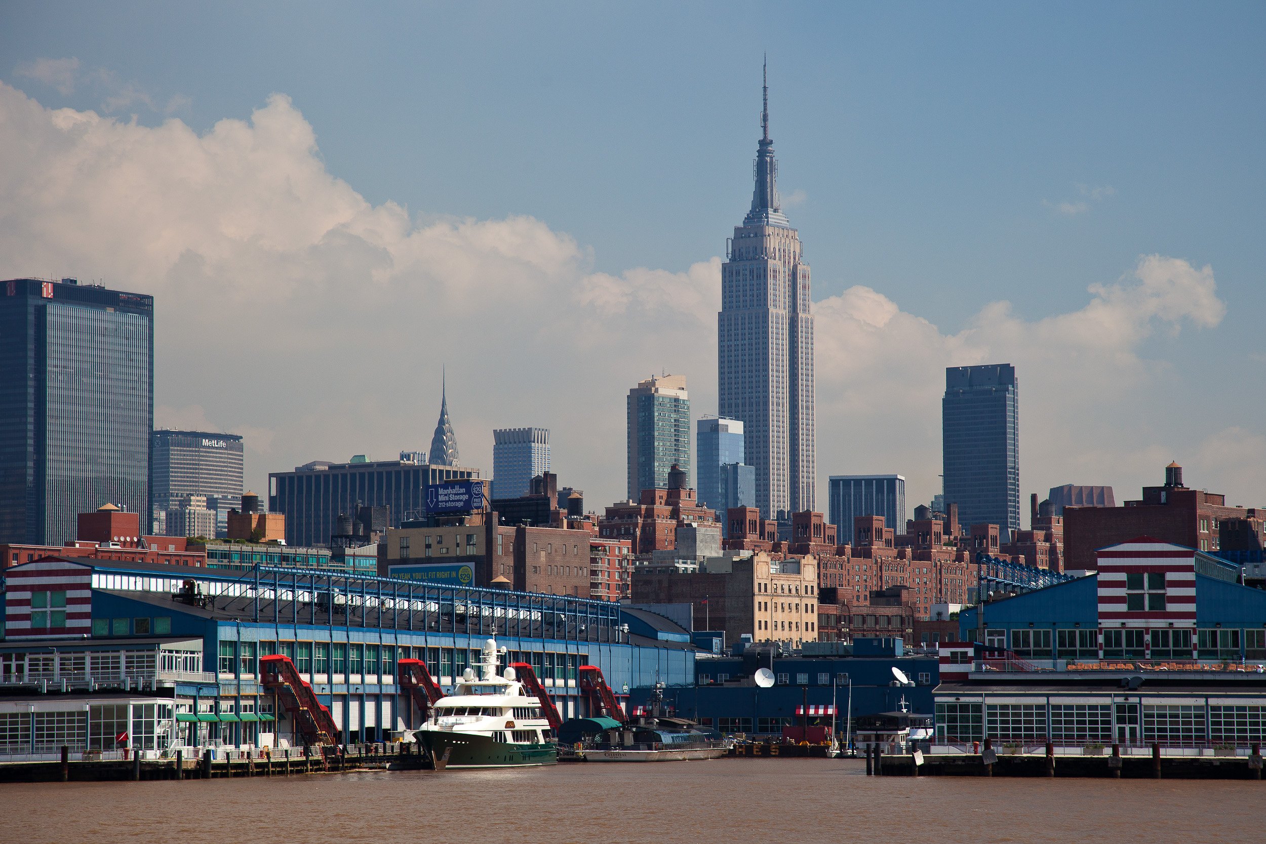 The Empire State Building rising above the waterfront and warehouses of Manhattan.