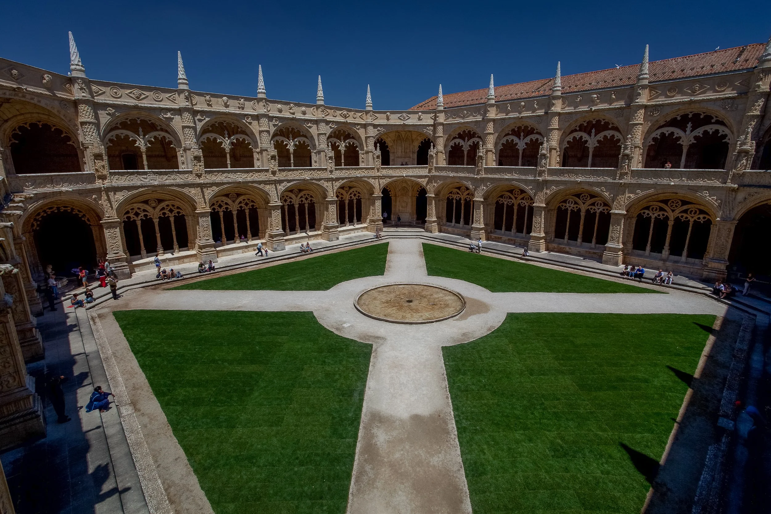 The cloister of Jerónimos Monastery in Belém, where carved stone arcades surround a quiet central courtyard.