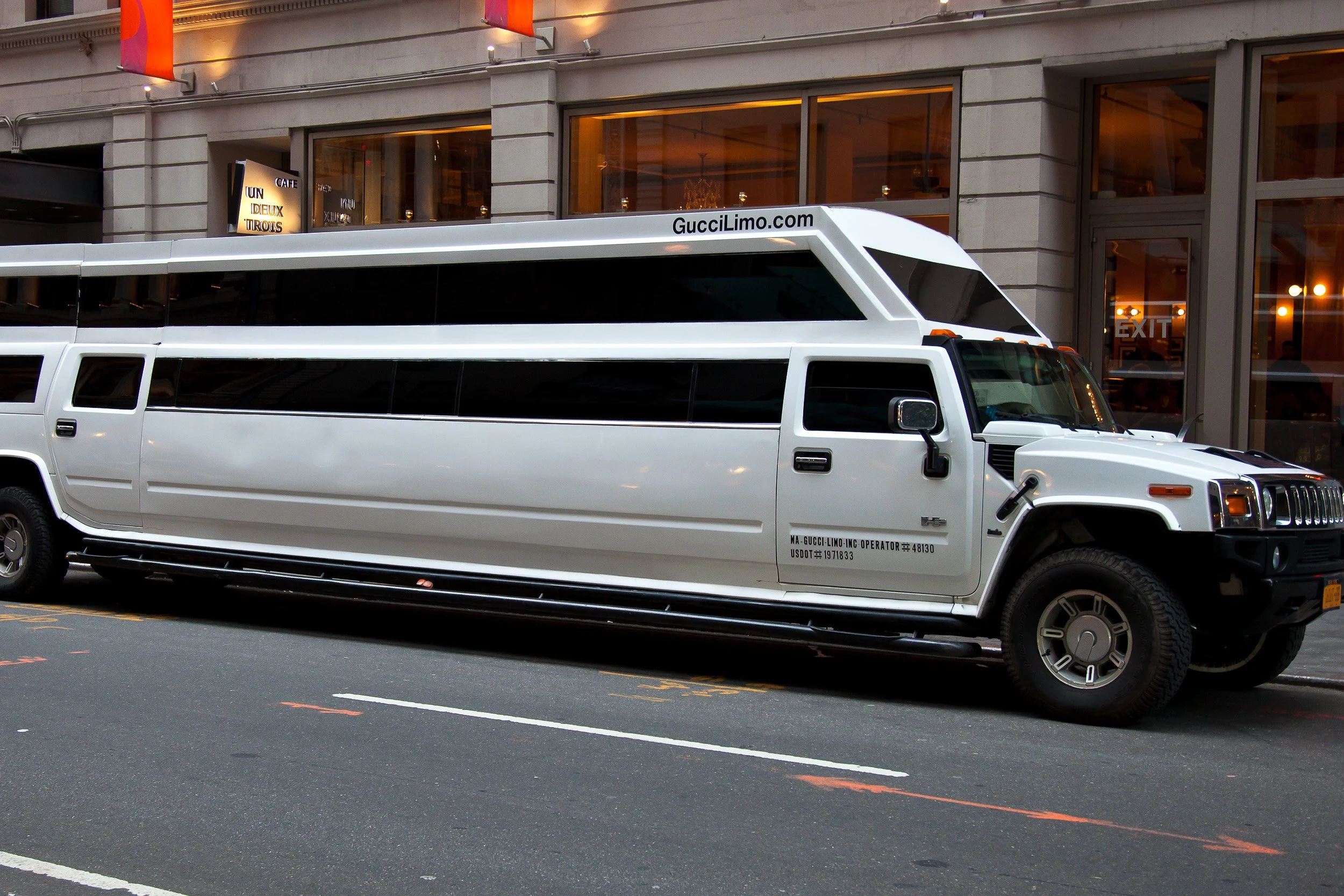 Stretch limousine parked beneath Midtown lights — a playful glimpse of New York’s larger-than-life street style.