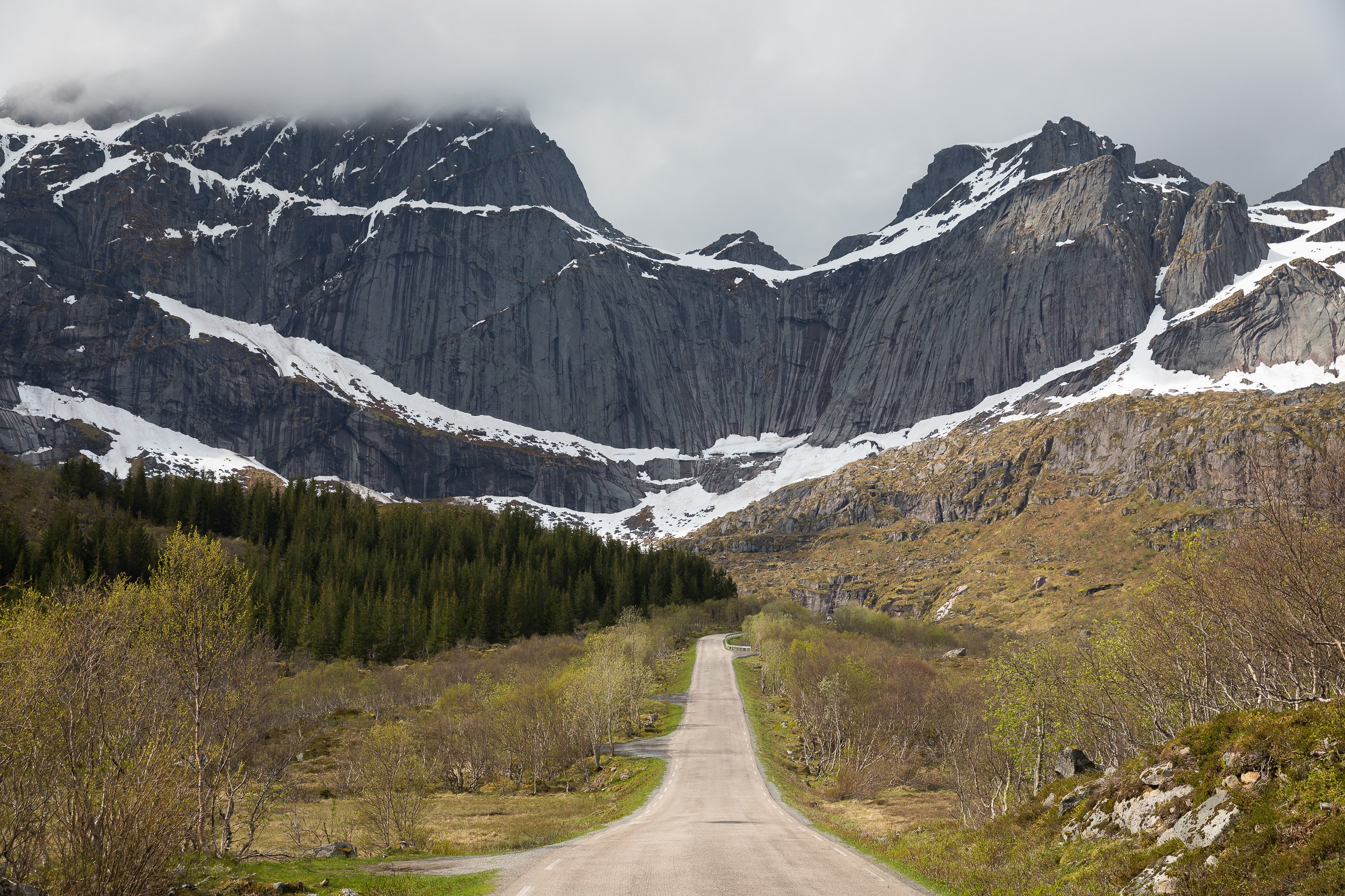 Road to Hell in the Lofoten Islands, Norway – winding coastal road between steep mountains and open sea.