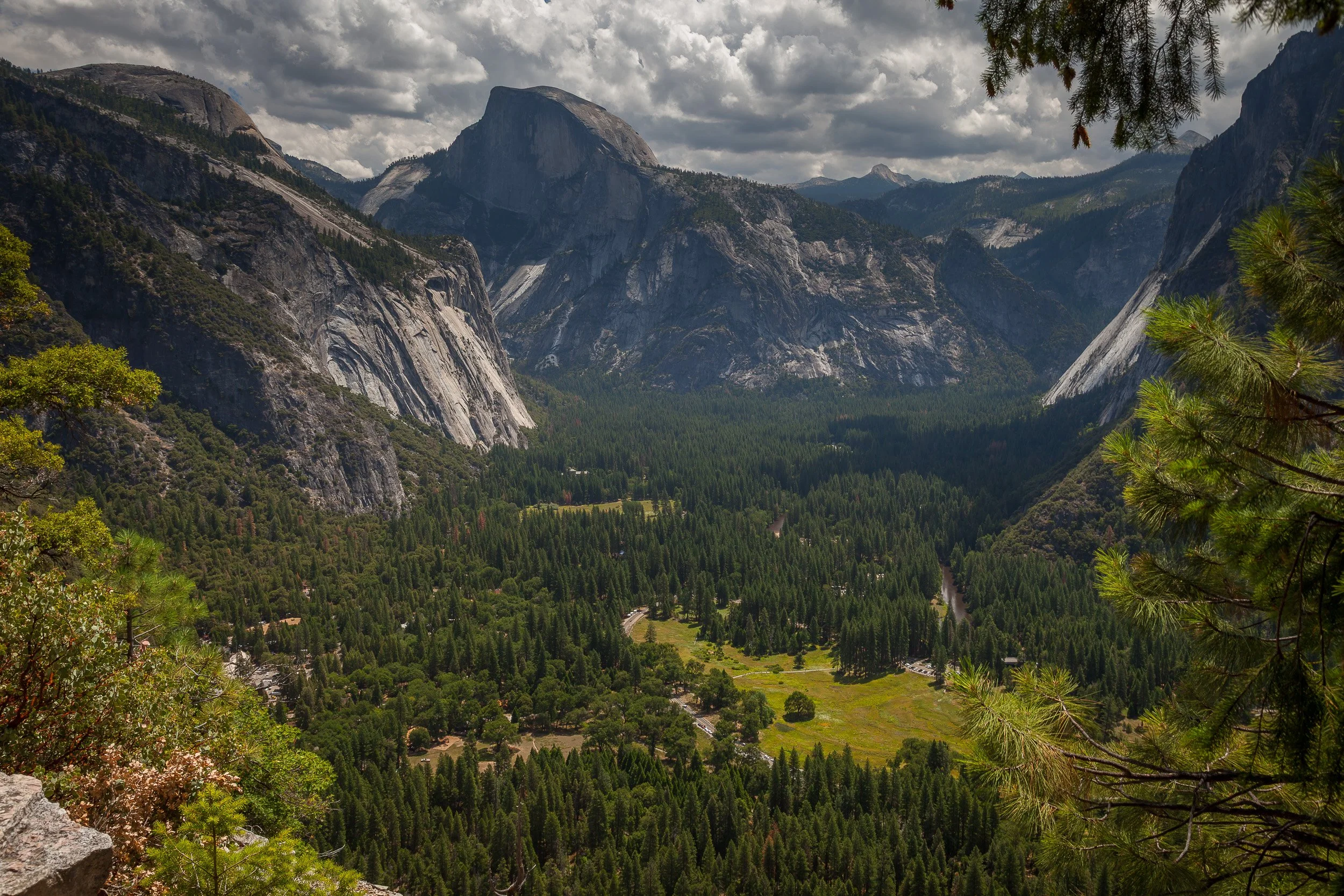 Half Dome and Yosemite Valley under dramatic clouds, California.
