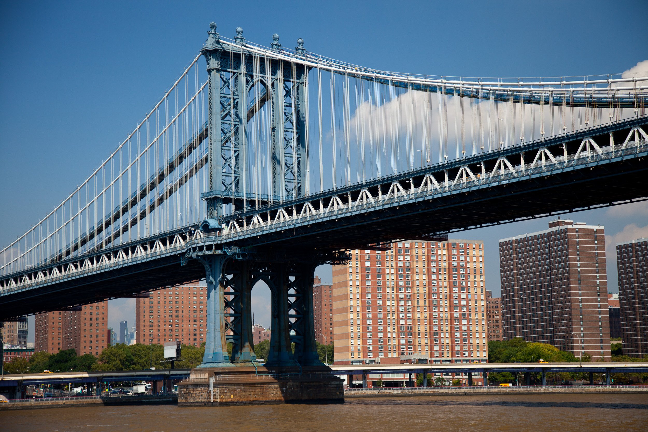 The steel lines of the Manhattan Bridge cutting boldly across the East River skyline.