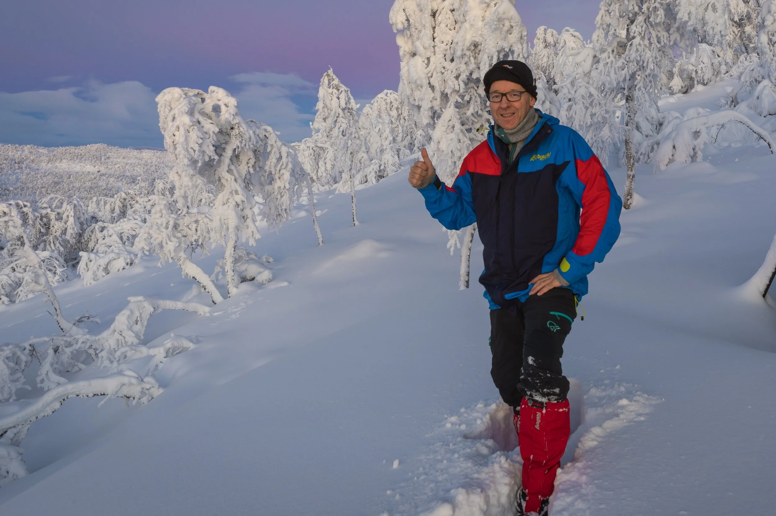 Svein Magne Tunli standing in deep snow among heavily frosted trees in a quiet winter landscape. A personal portrait that reflects the outdoor, atmospheric and nature-led identity of Tunliweb.