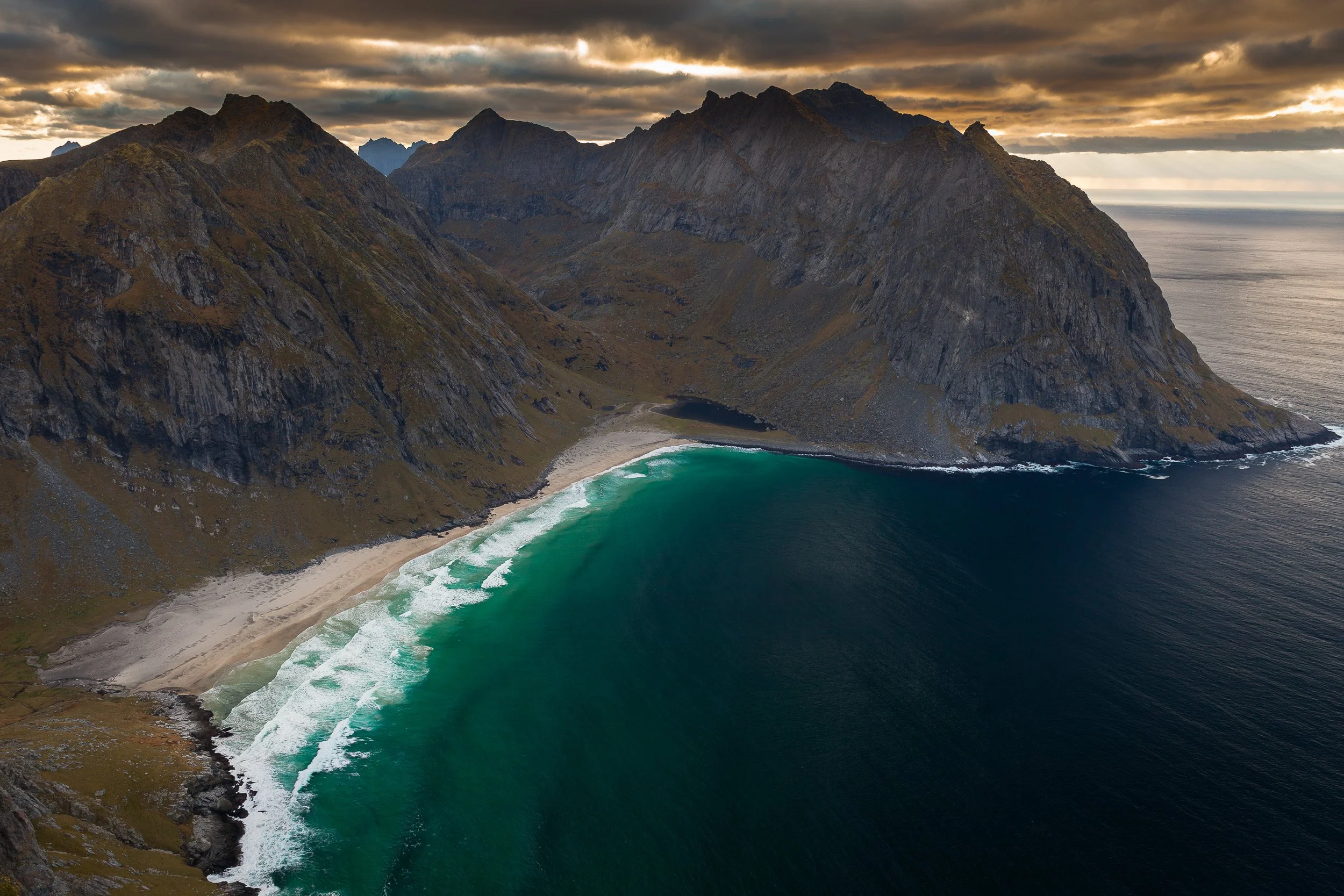 Kvalvika Beach in the Lofoten Islands, Norway – remote sandy bay enclosed by steep mountains facing the open ocean.