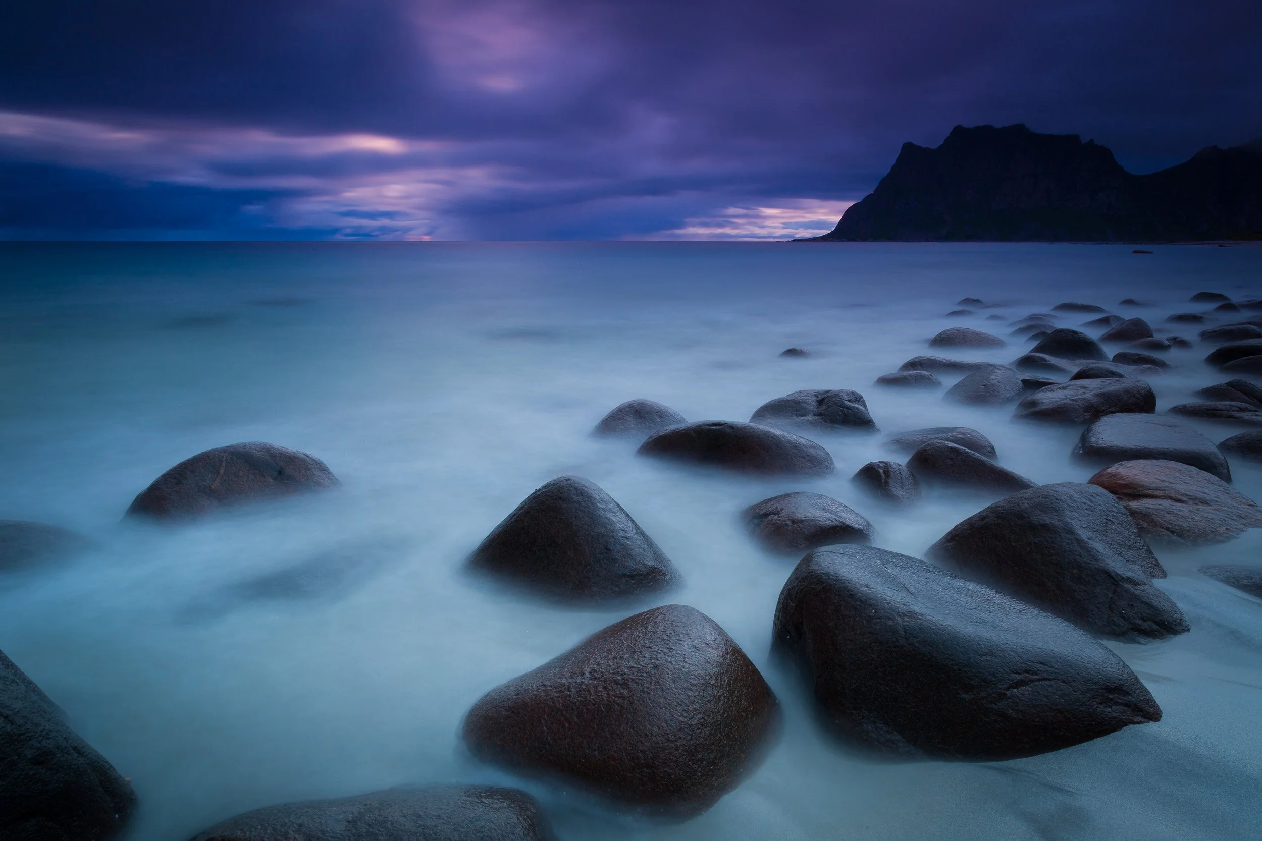Utakleiv Beach in the Lofoten Islands, Norway – rocky shoreline, smooth boulders and open view to the Norwegian Sea.