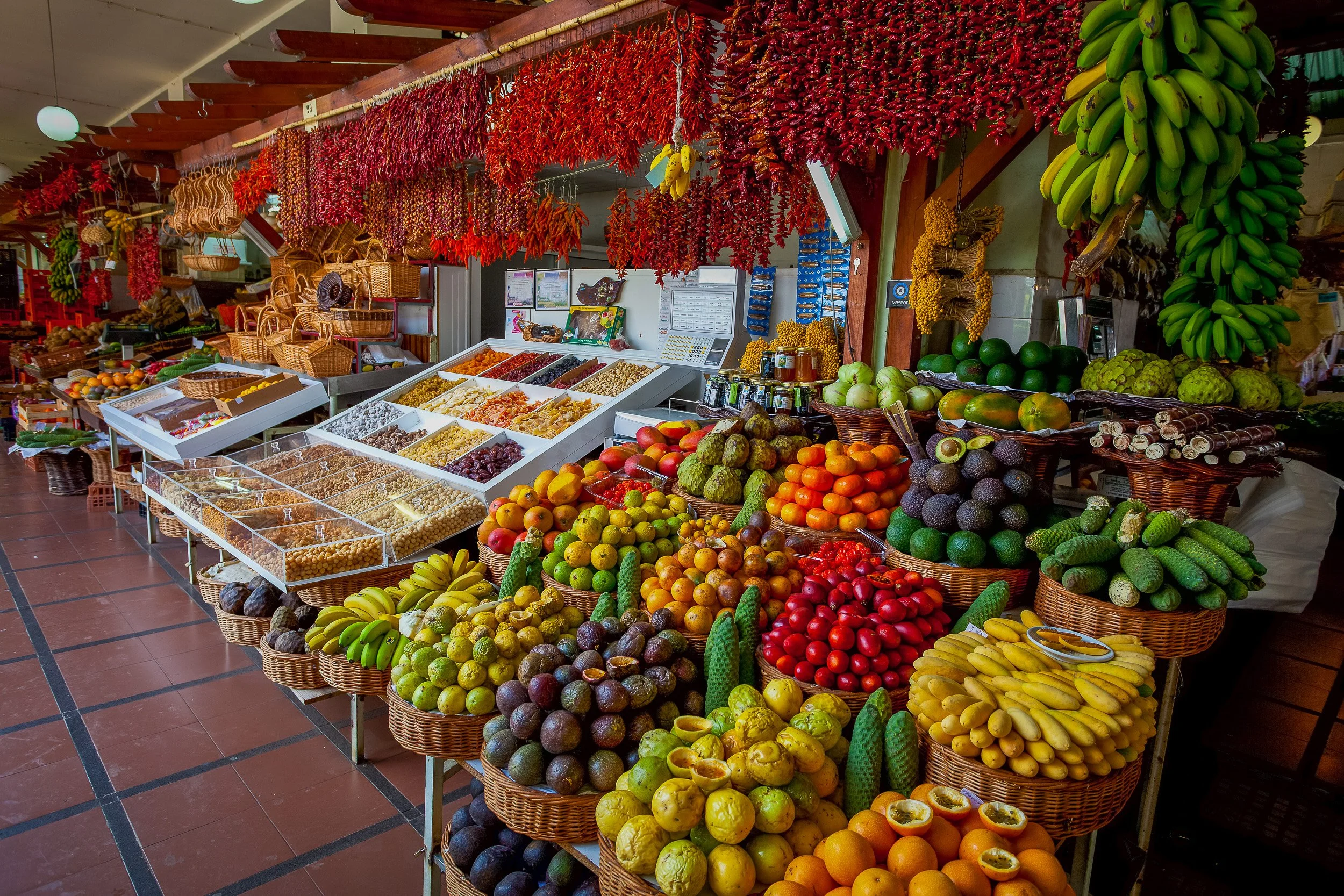 A rich display of fruit, vegetables, dried peppers and local produce inside Funchal’s market, where colour, texture and abundance give the scene its energy.