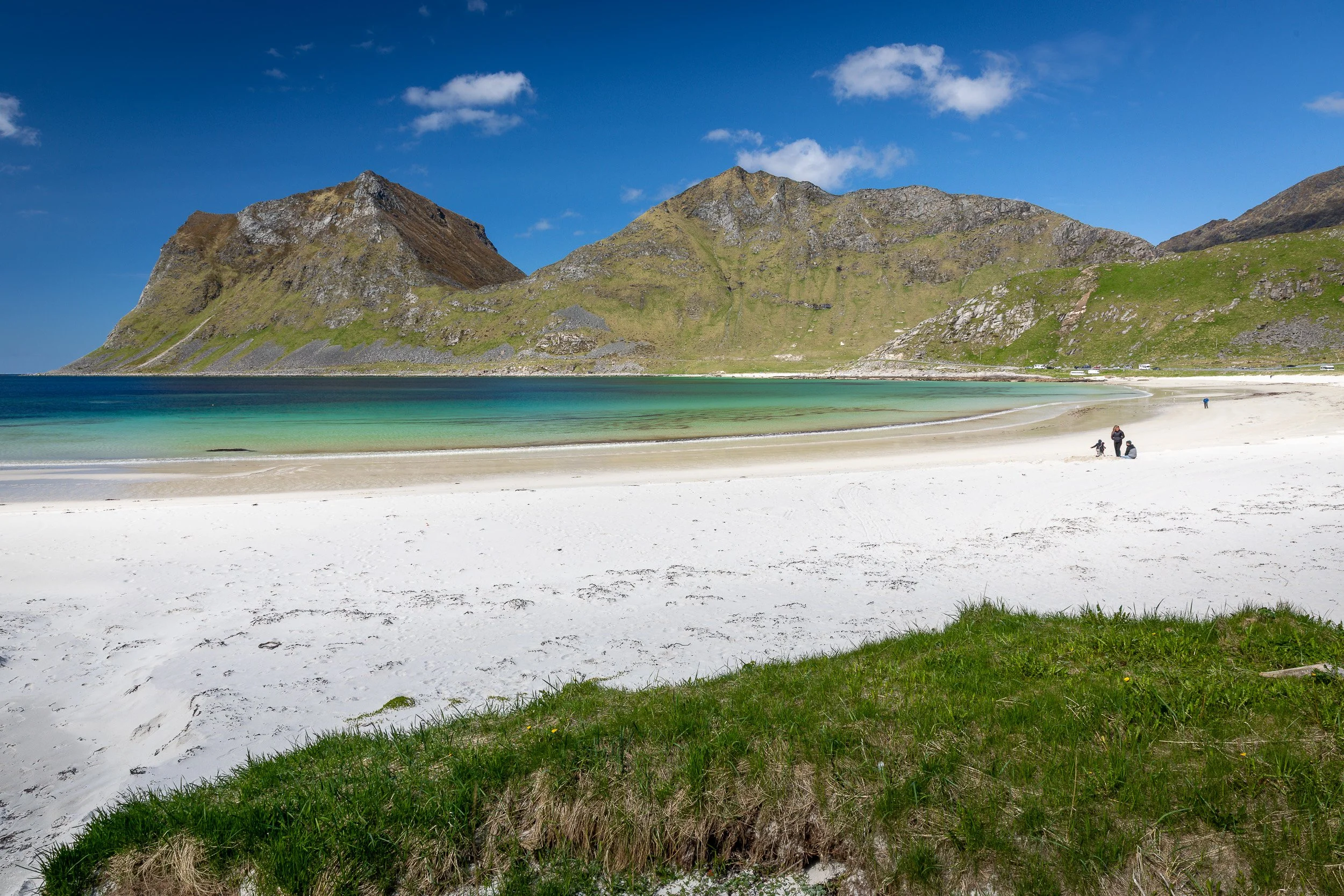 Haukland Beach in the Lofoten Islands, Norway – gentle waves, curved bay and soft sand below rounded hills.