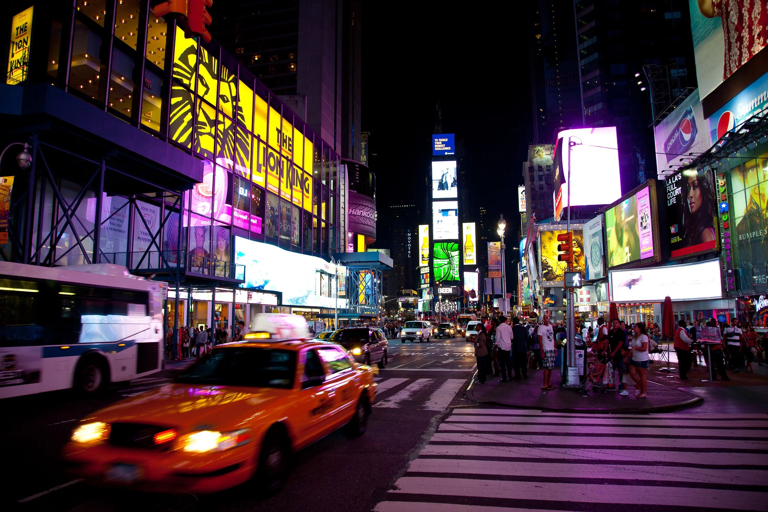 Times Square after dark, where neon, traffic and yellow cabs turn the crossroads into pure theatre.