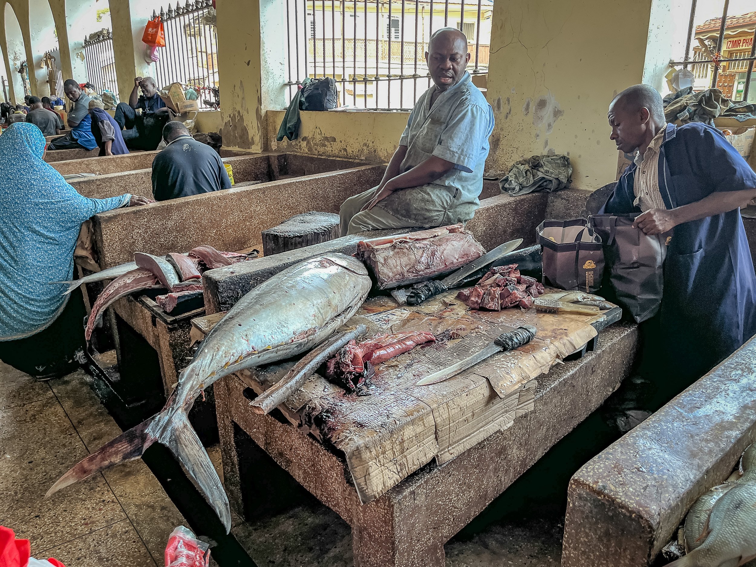 Busy main fish market in Stone Town, Zanzibar – close-packed stalls, colourful produce and crowds of locals creating a lively, authentically East African atmosphere.