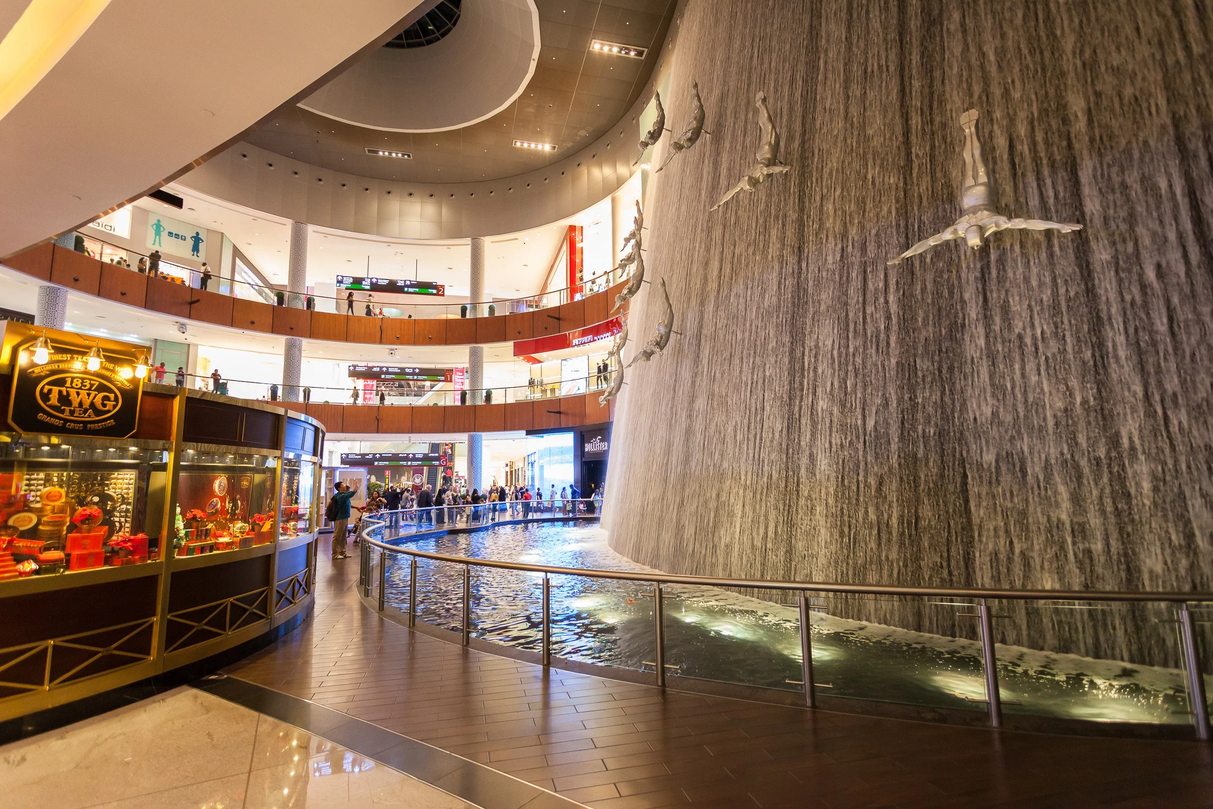 The famous waterfall installation inside Dubai Mall, with divers suspended in motion.