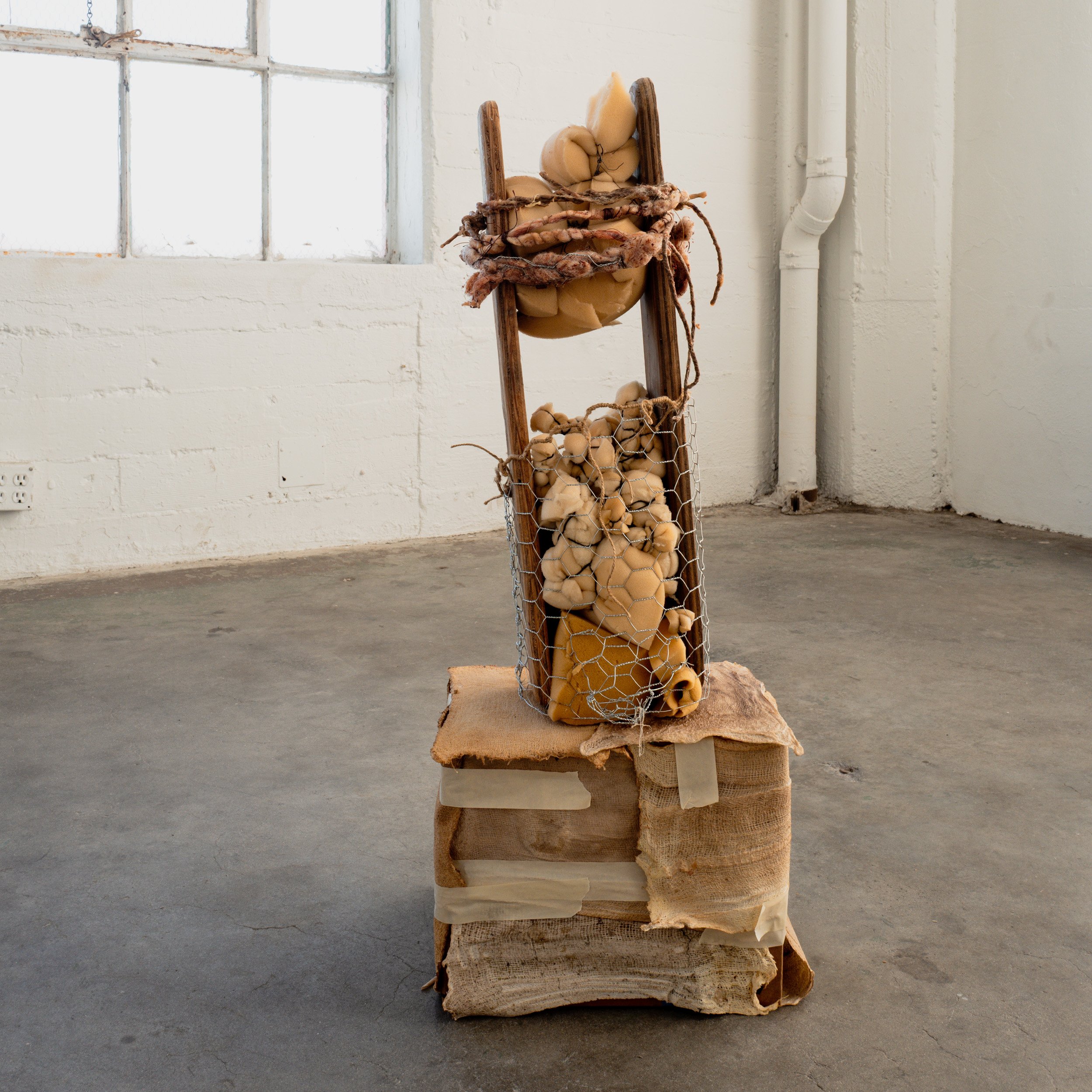 UNTITLED (LET ME HOLD YOU) | TK" x KT" x TK" | Foam, wire, twine, found object (Wood industrial ironing board for sleeves). 