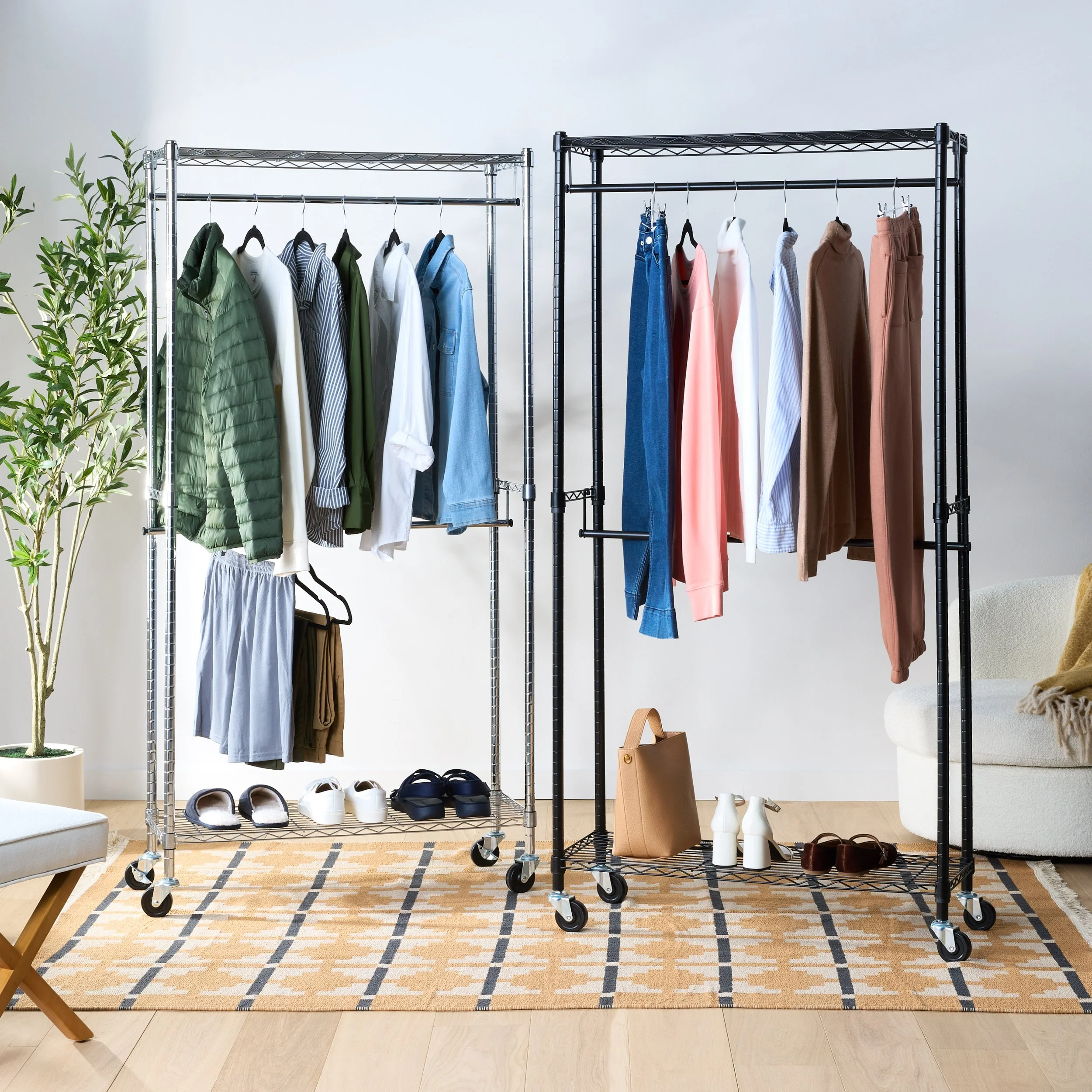 Two clothing racks filled with various shirts, pants, and jackets in different colors inside a living room, with shoes and bags on the floor and decor on the walls and furniture.