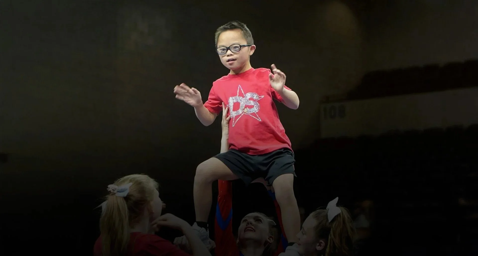 A special needs student performing a lift with their Dakota Spirit teammates.
